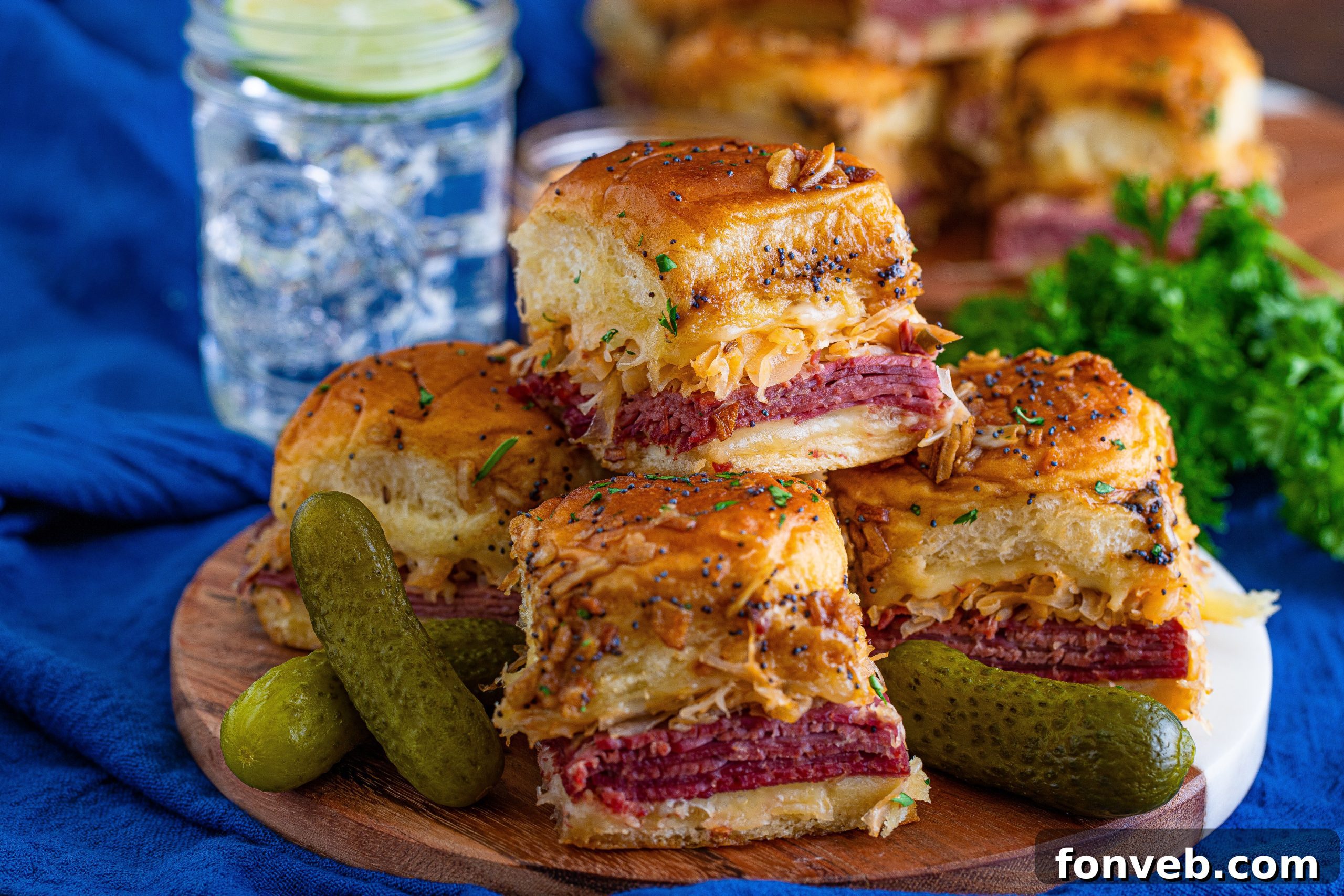A serving of Reuben Sliders with a side of extra dressing for dipping.