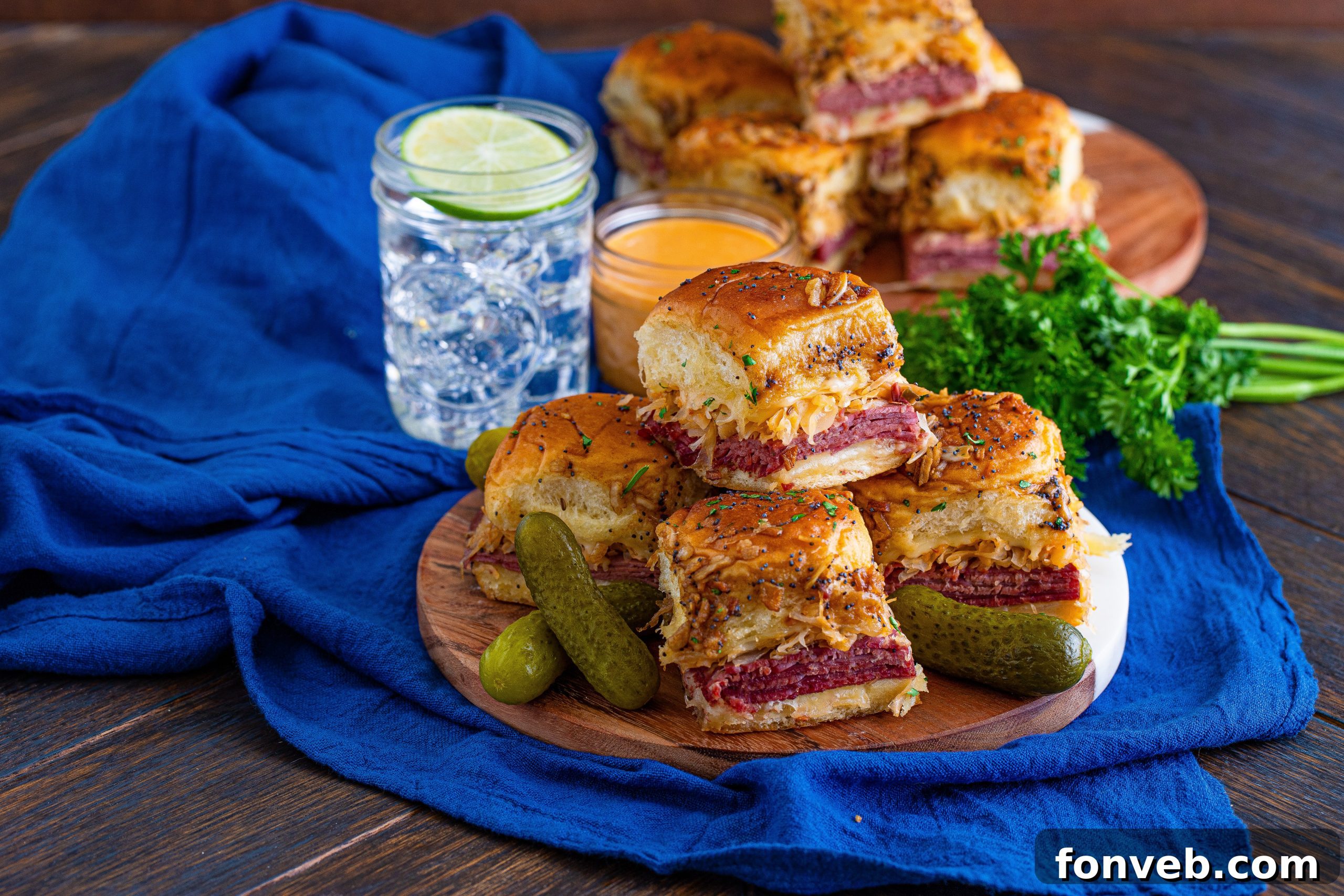 Close-up view of the golden, poppy seed crusted tops of the Reuben Sliders.