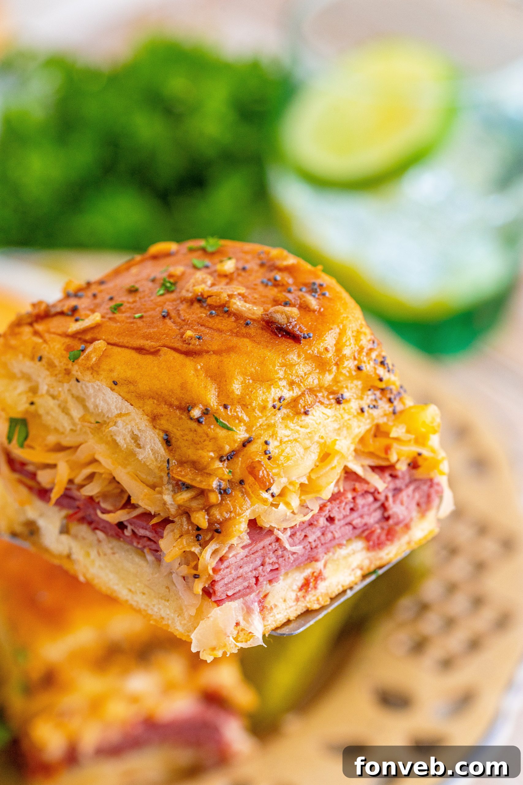A full baking dish of hot, ready-to-serve Reuben Sliders.