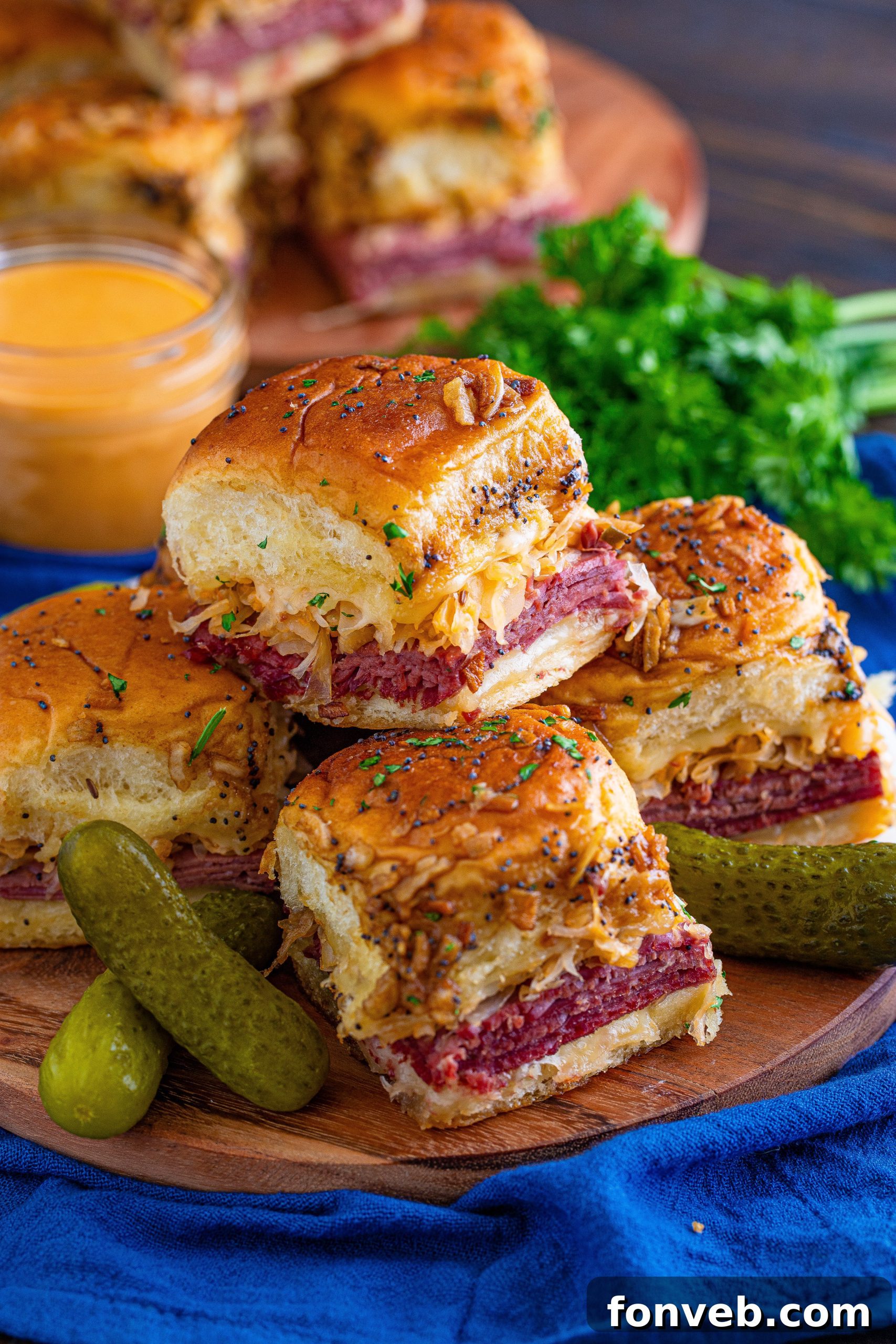 Several Reuben Sliders pulled apart, showing the steam and melted cheese.