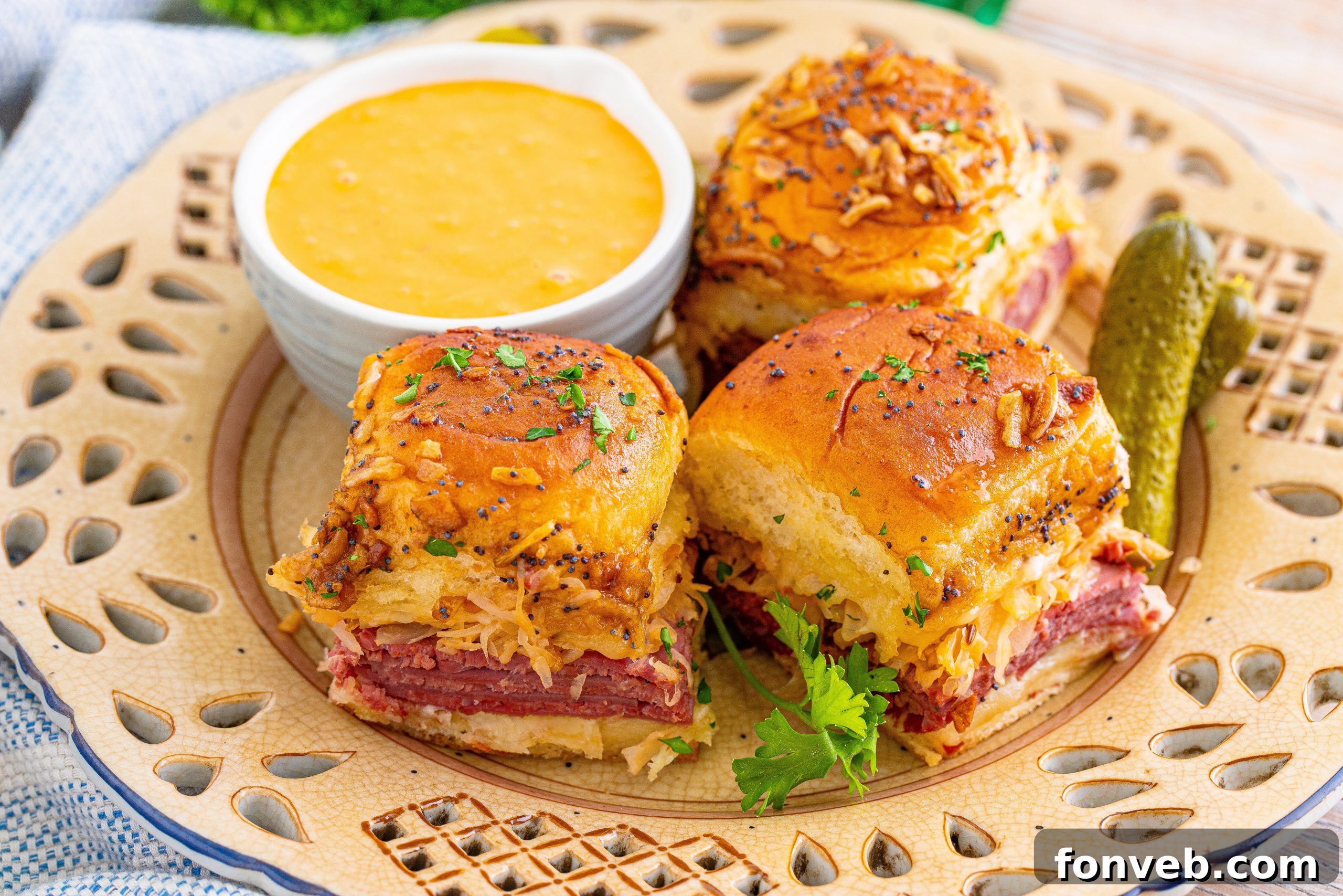 A close-up of a single Reuben Slider with a golden, poppy-seed topping.