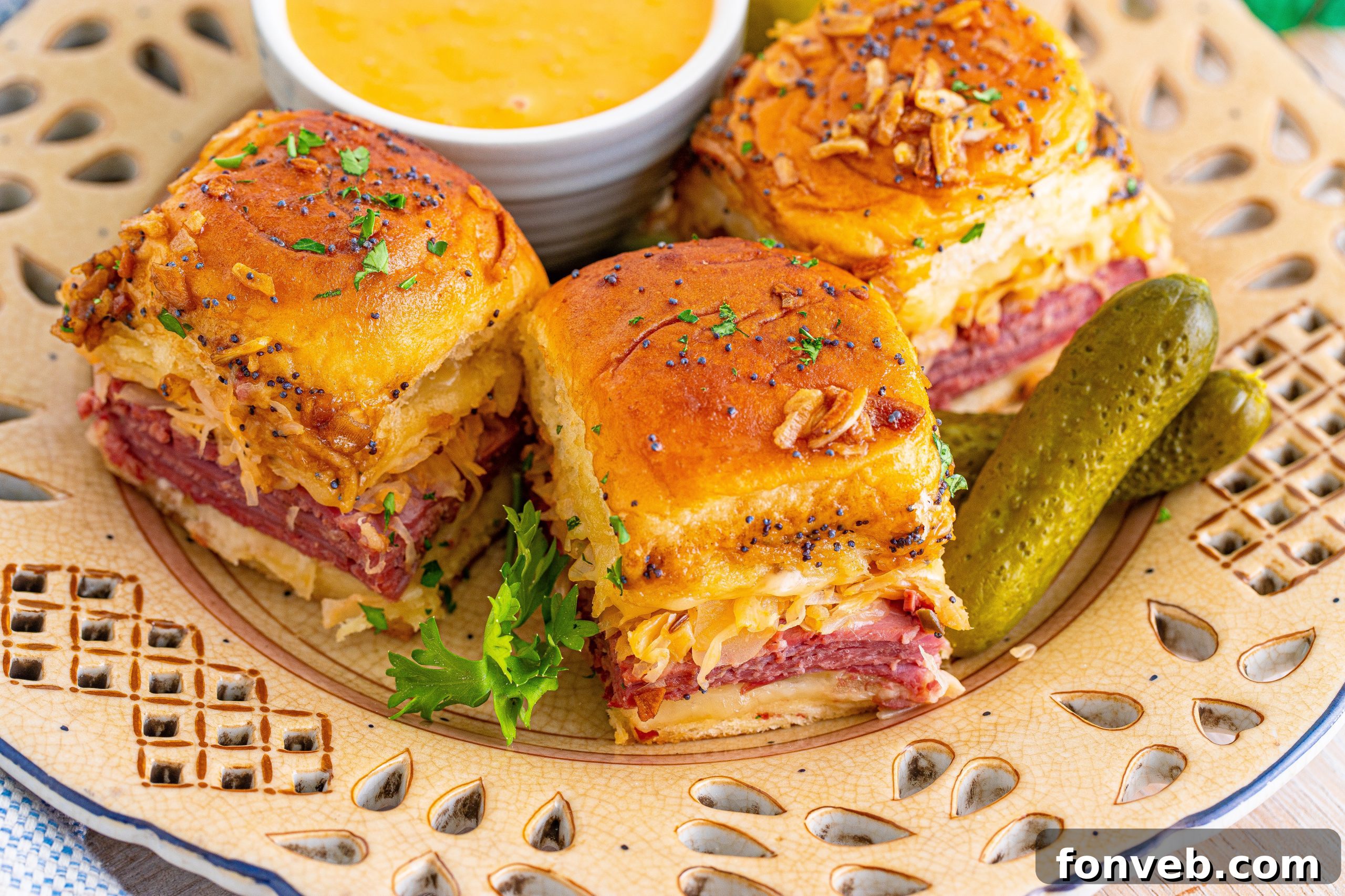 Reuben Sliders ready to be eaten, stacked slightly on a serving plate.