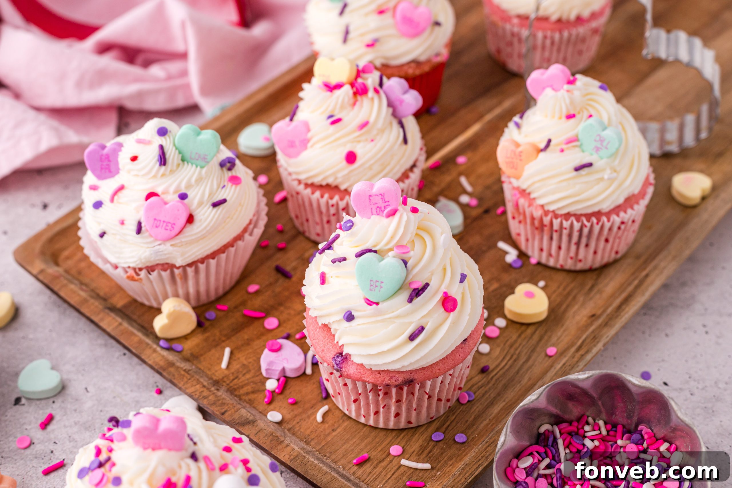 Blushing Velvet Vanilla Cupcakes 6 Close-up of a bowl of pink and purple sprinkles, often used for decorating cupcakes.