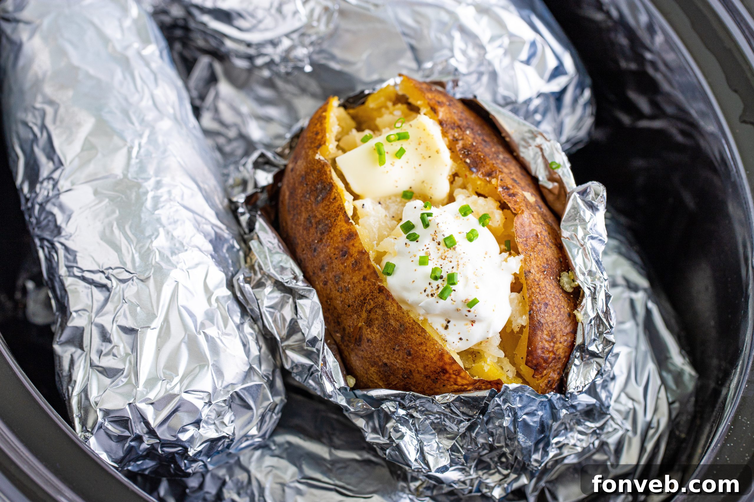 A rustic basket filled with raw, unpeeled russet potatoes, ready for preparation