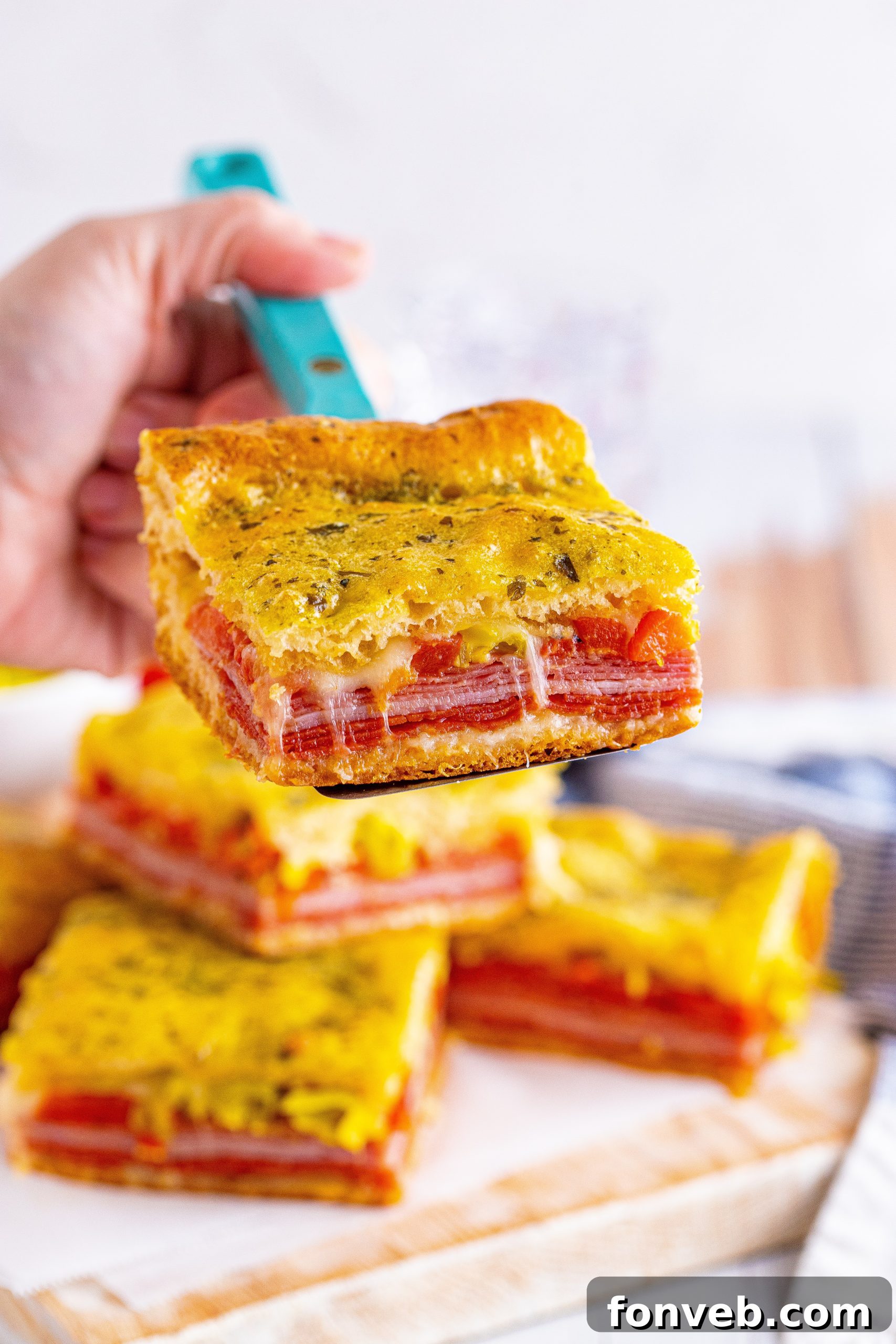 Several Italian Antipasto Squares arranged artfully on a serving tray.