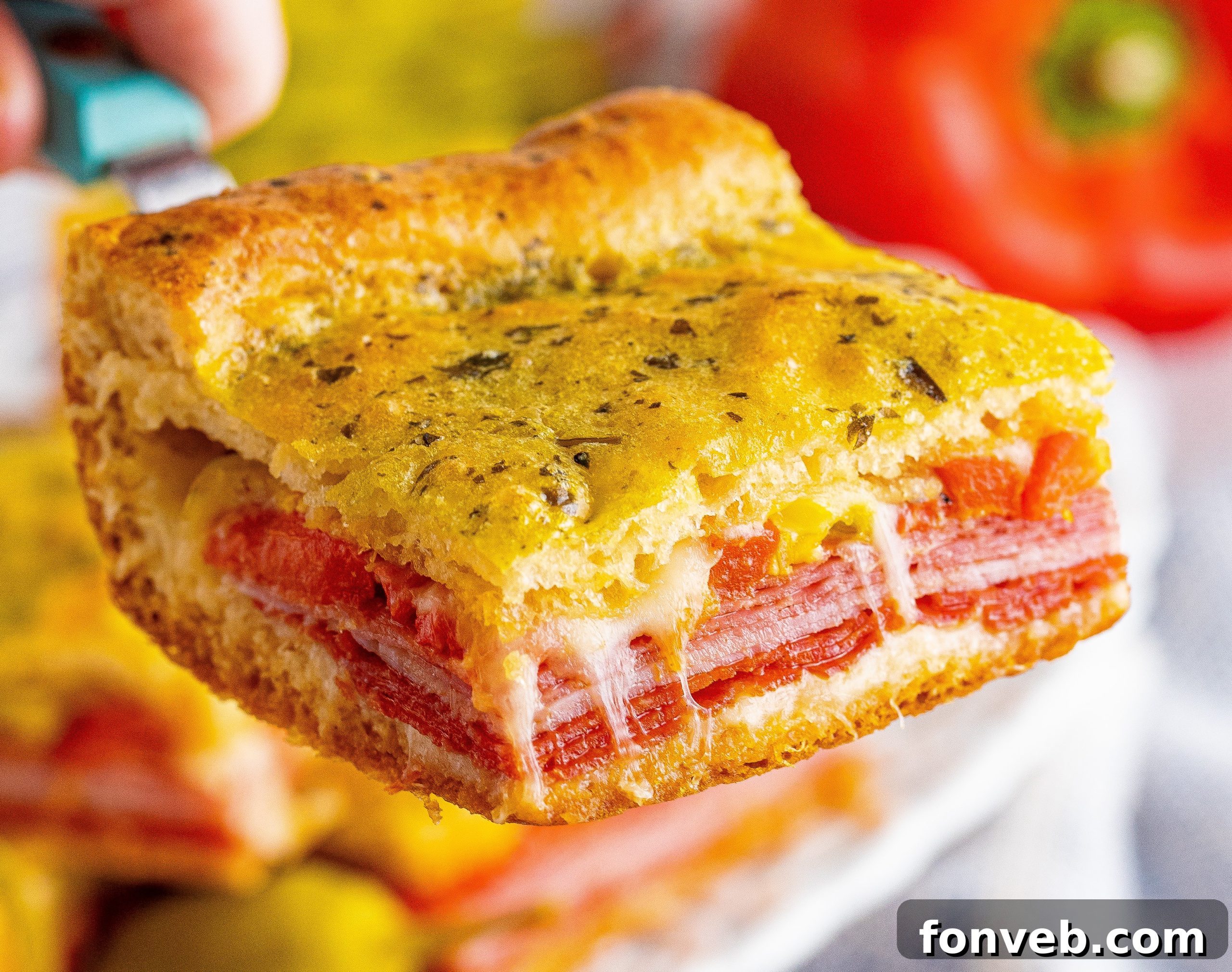 A large tray of Italian Antipasto Squares cooling after being baked, with some already cut.