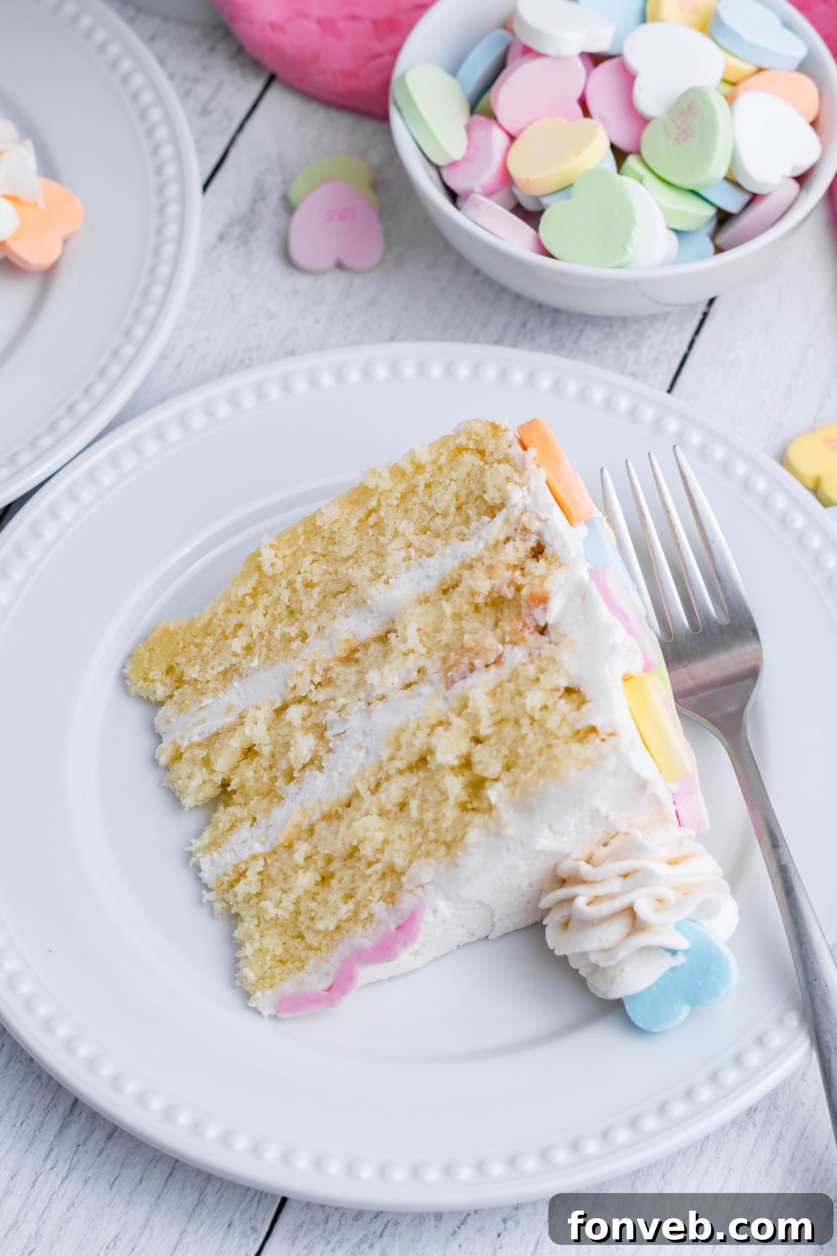 Pink frosting details on a Conversation Hearts Cake