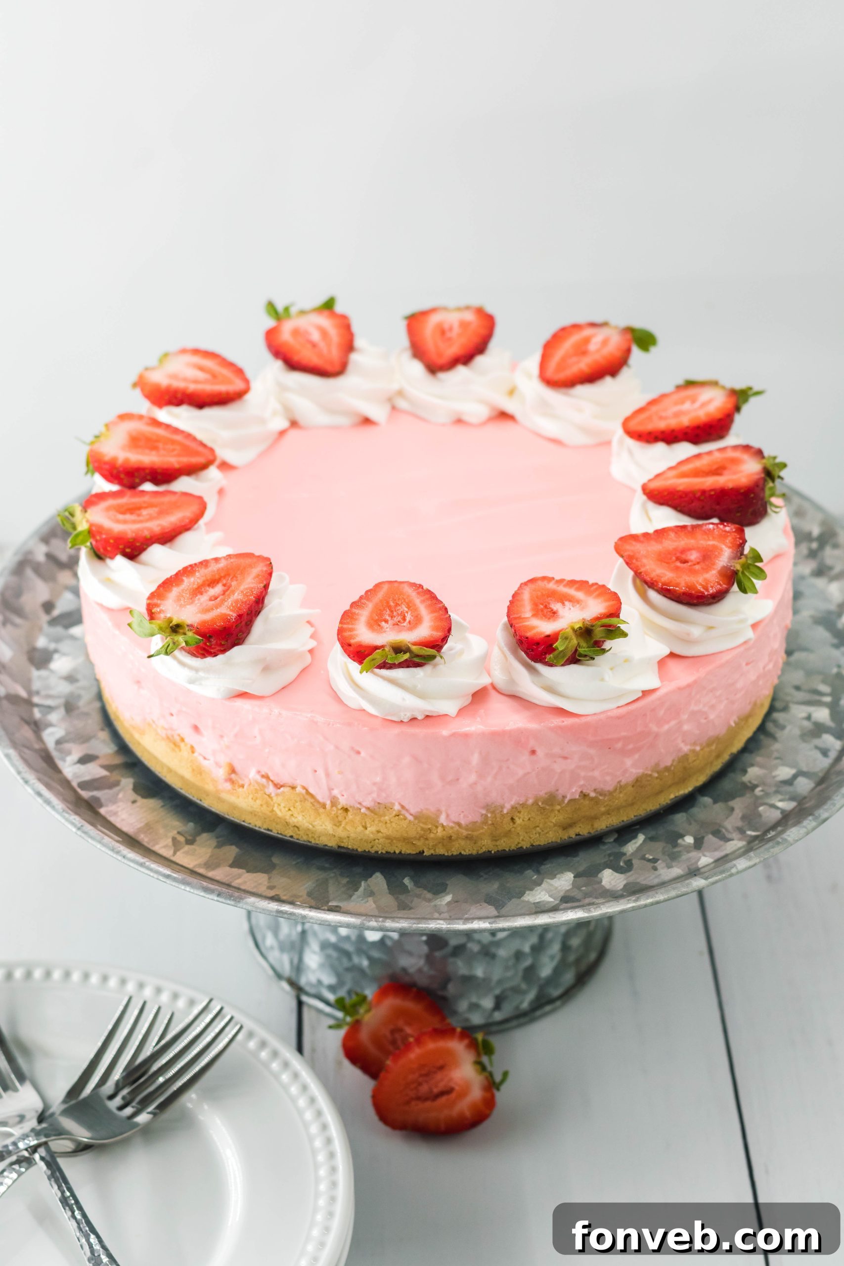 Luscious No-Bake Strawberry Cheesecake 3 A full No Bake Strawberry Cheesecake showcasing its vibrant pink color and smooth texture, ready to be sliced.
