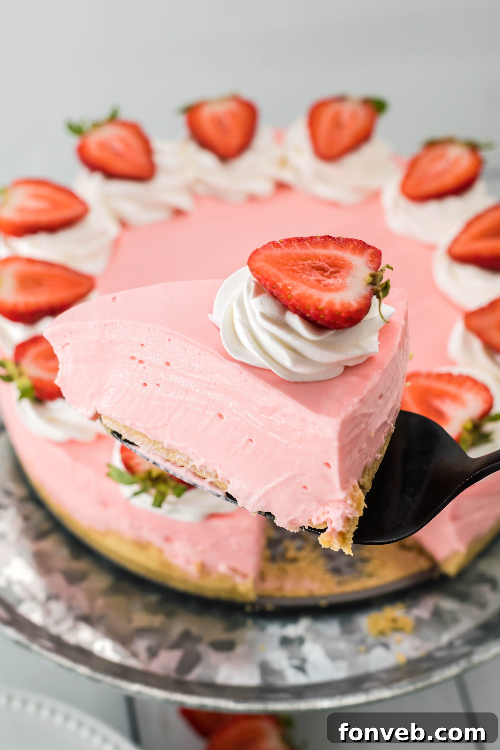 Top-down view of the entire No Bake Strawberry Cheesecake, garnished with whole fresh strawberries.