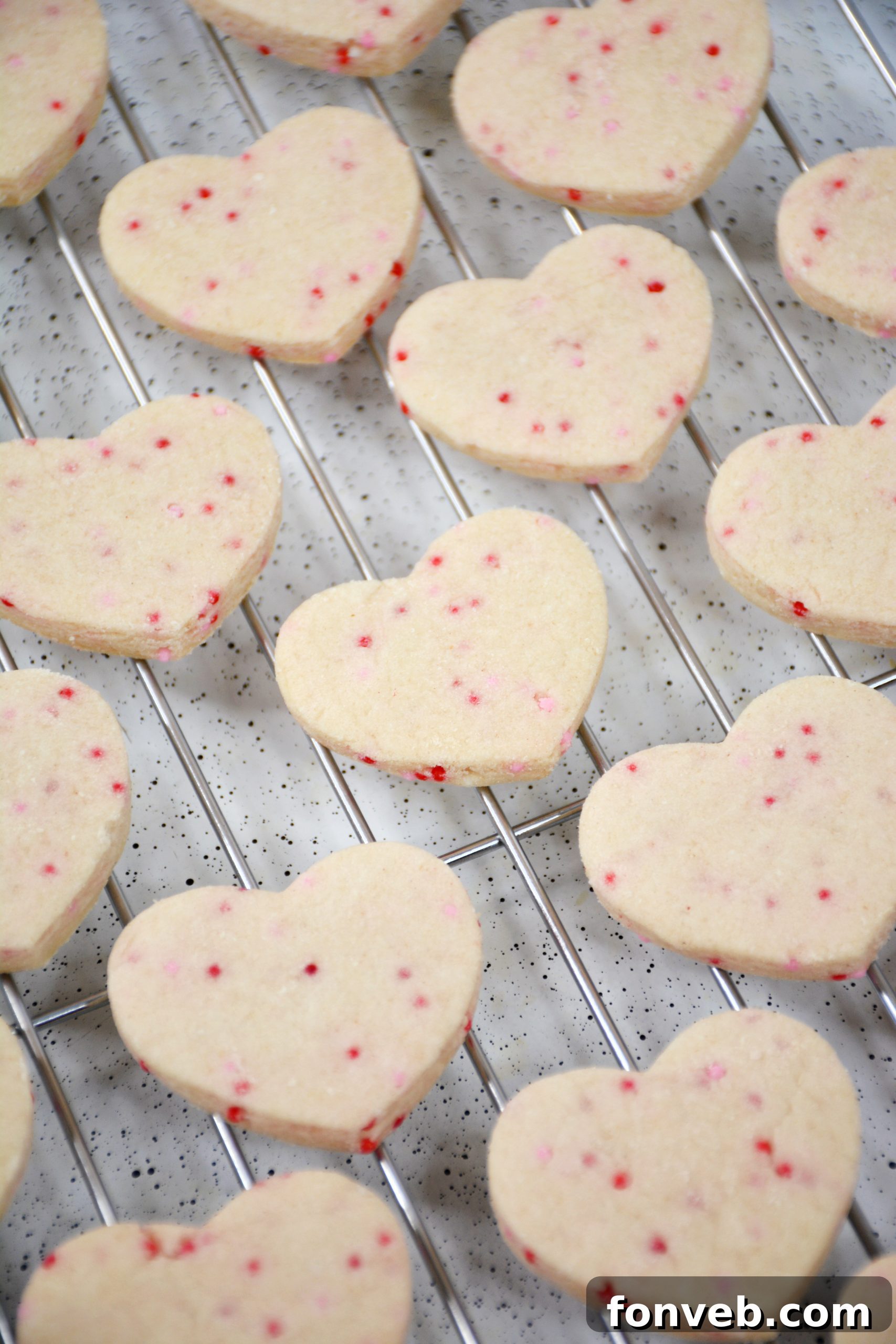 Assorted Valentine's Day Shortbread Cookie Bites on a rustic wooden surface, highlighting their homemade appeal.