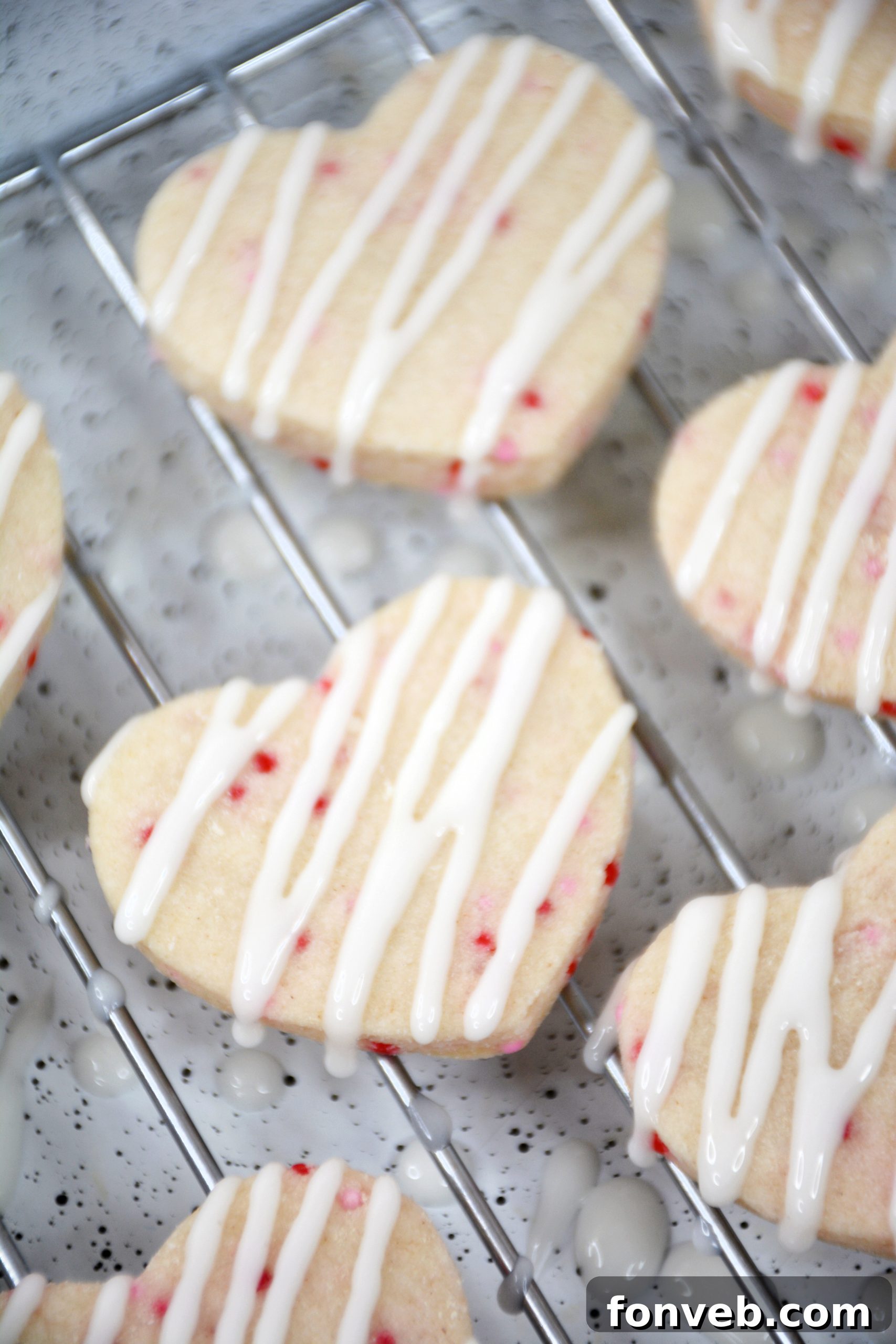 Heart-shaped Valentine's Day Shortbread Cookie Bites arranged artistically, ready for decoration.