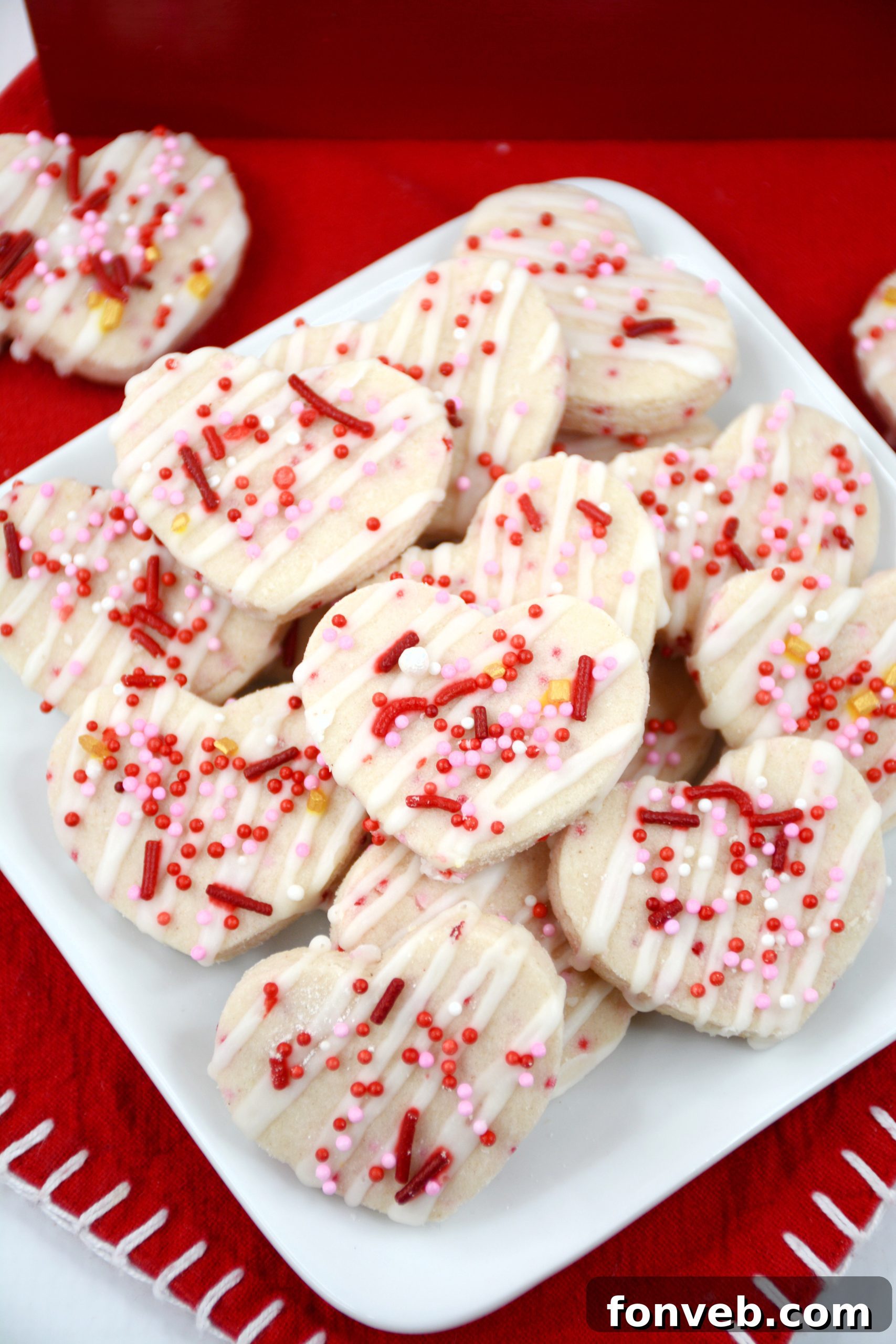 Various baking tools, including cookie cutters and a rolling pin, on a flour-dusted surface.