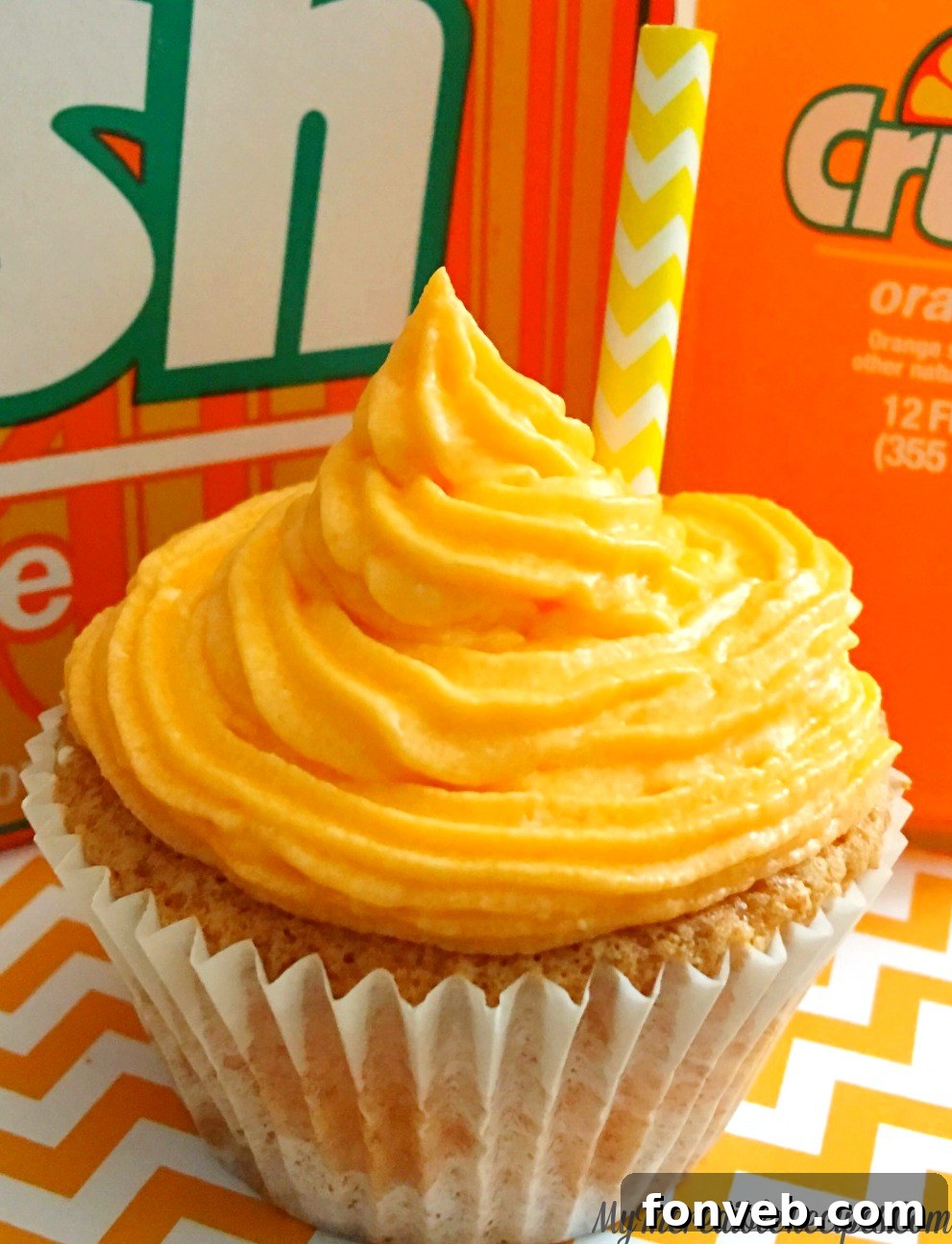 Delicious Orange Creamsicle Cupcakes with a creamy swirl frosting and a paper straw garnish.