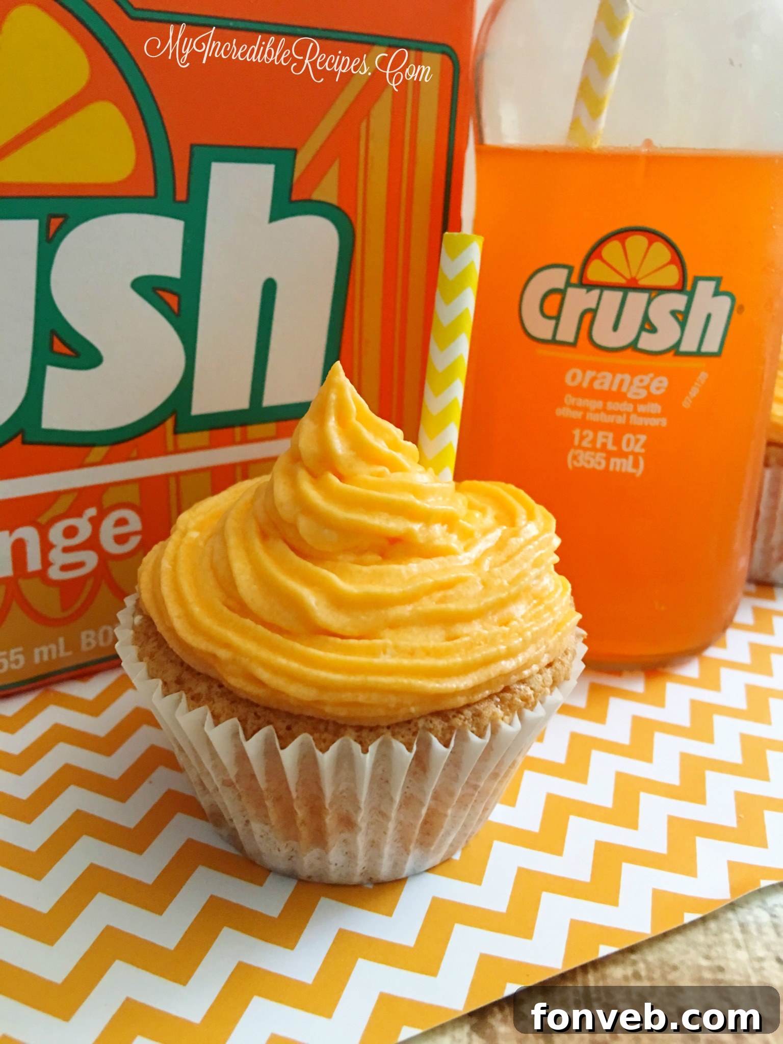 Close-up of a single Orange Creamsicle Cupcake, perfectly frosted and inviting.