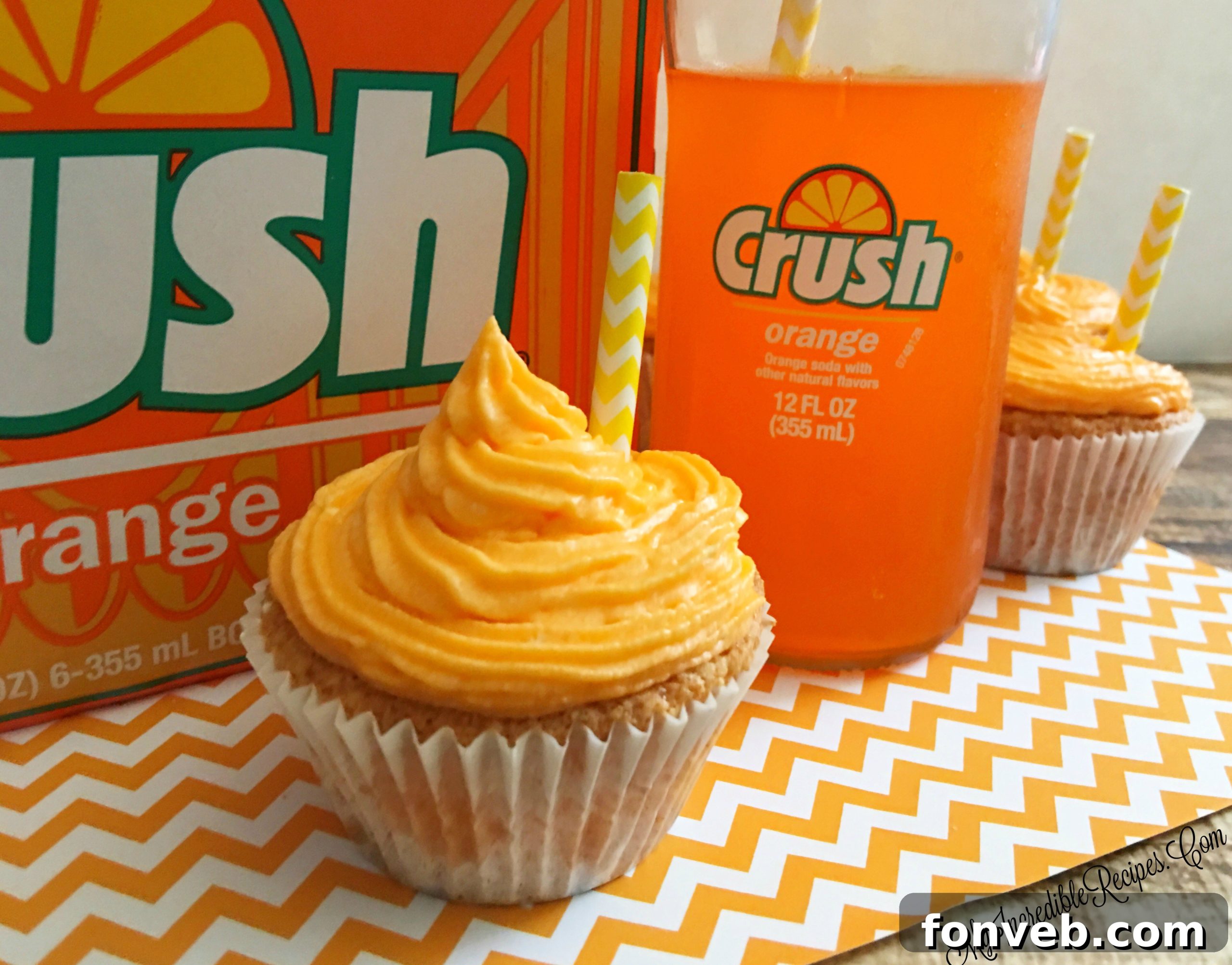 Several Orange Creamsicle Cupcakes on a tray, showing their delicious frosting.
