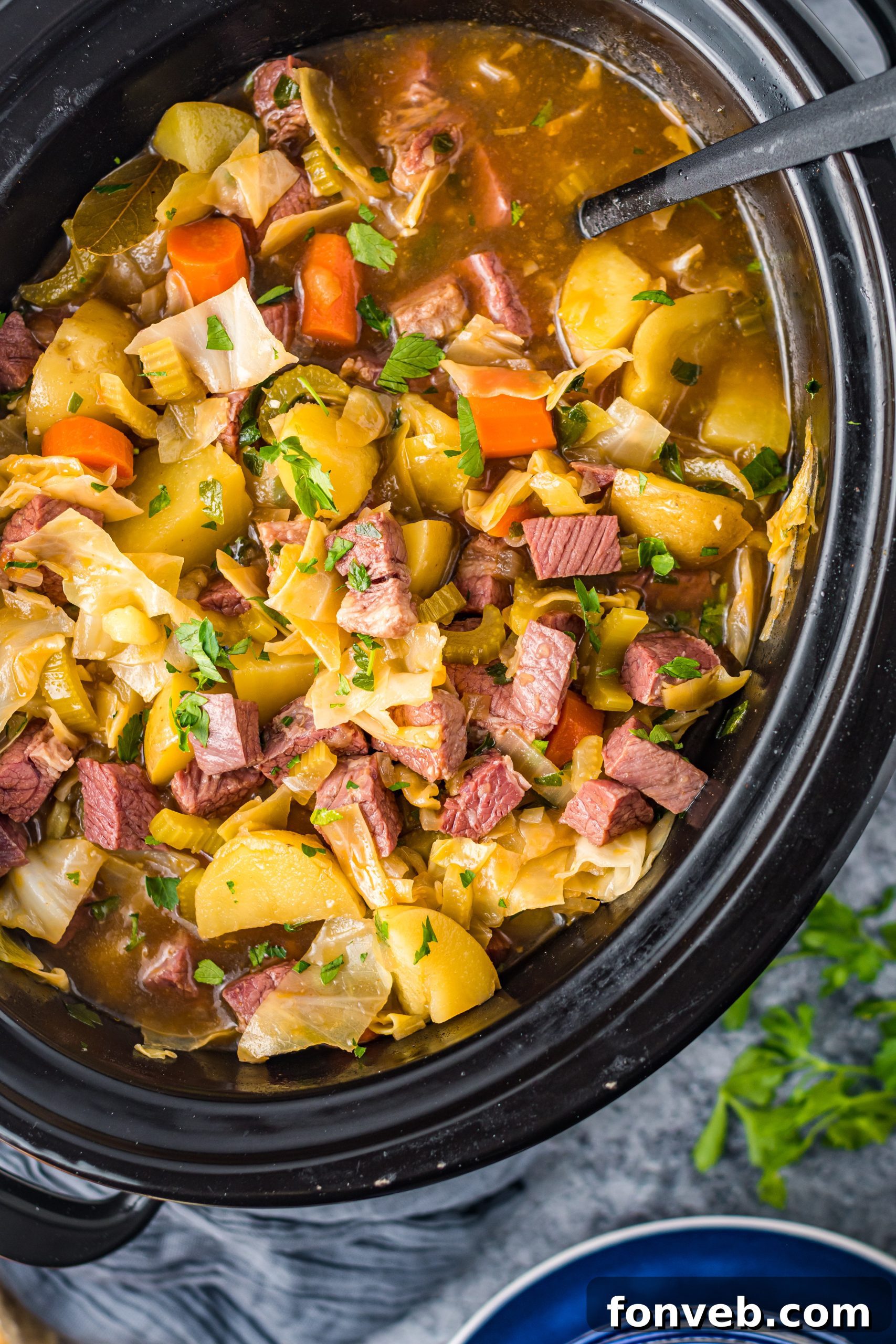 Slow Cooker Corned Beef and Cabbage Soup, overhead shot with spoon