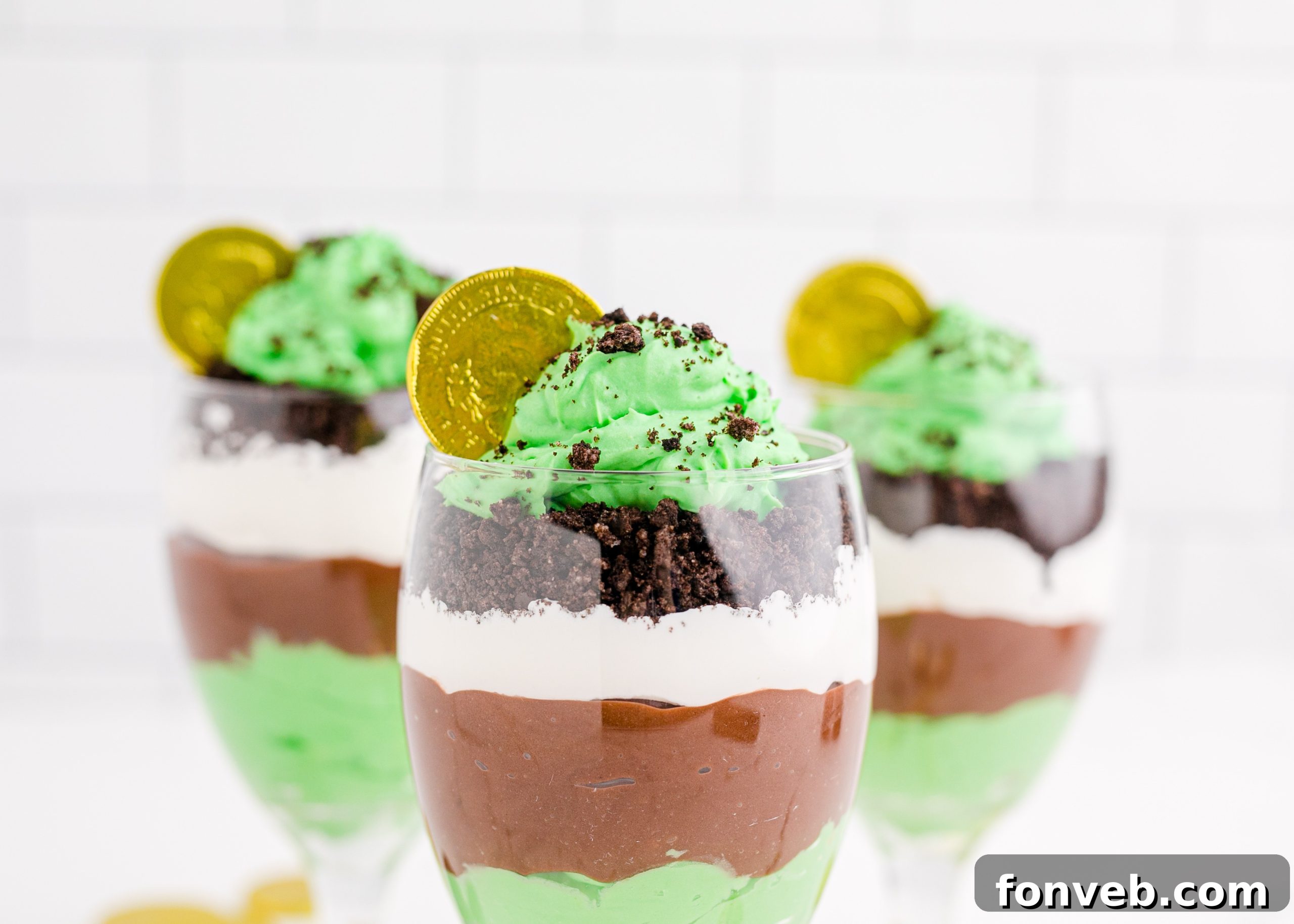 Three St. Patrick's Day Pudding Cups on a white background with green accents