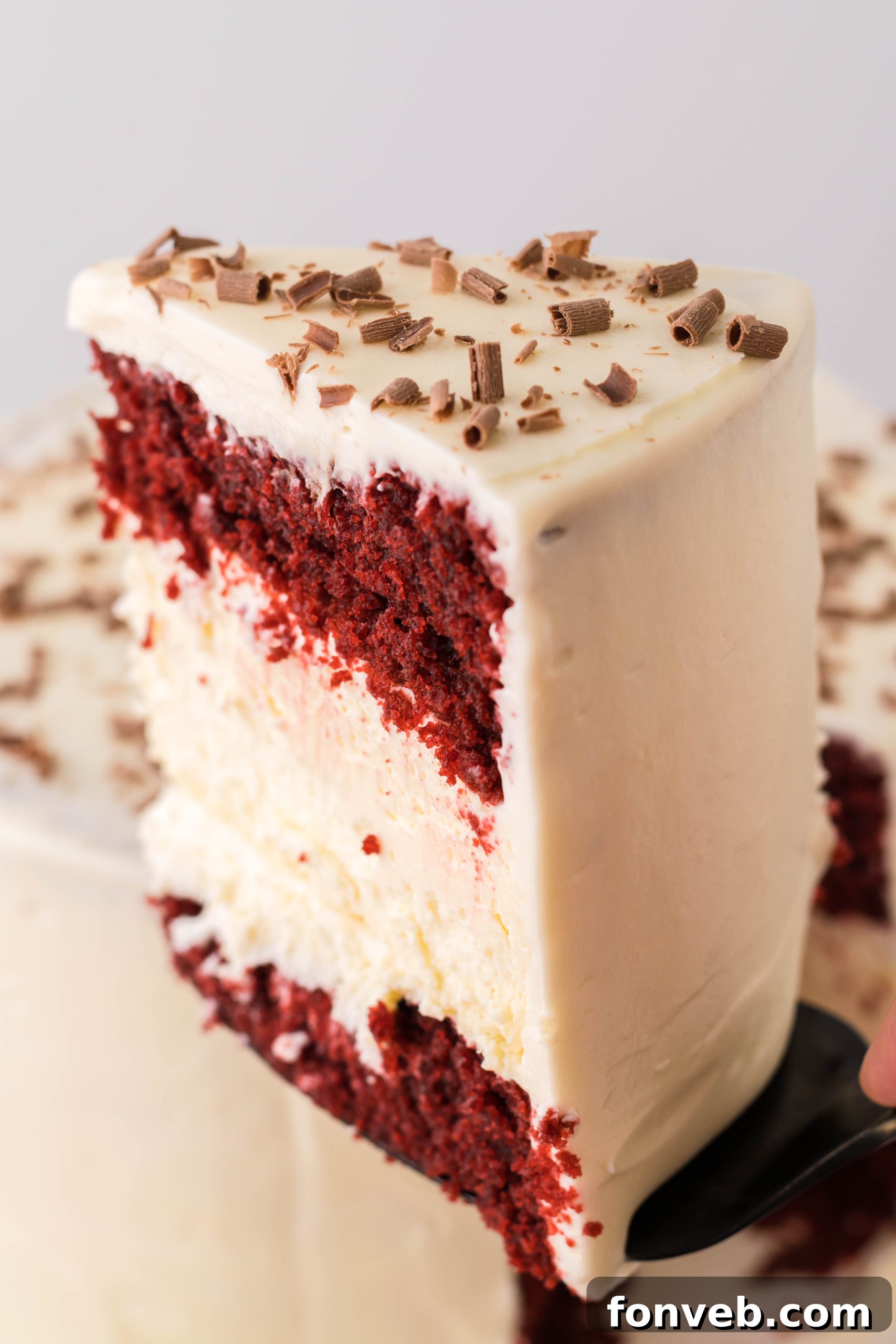 Another perspective of the assembled Red Velvet Cheesecake Cake, showing its impressive height and layers.