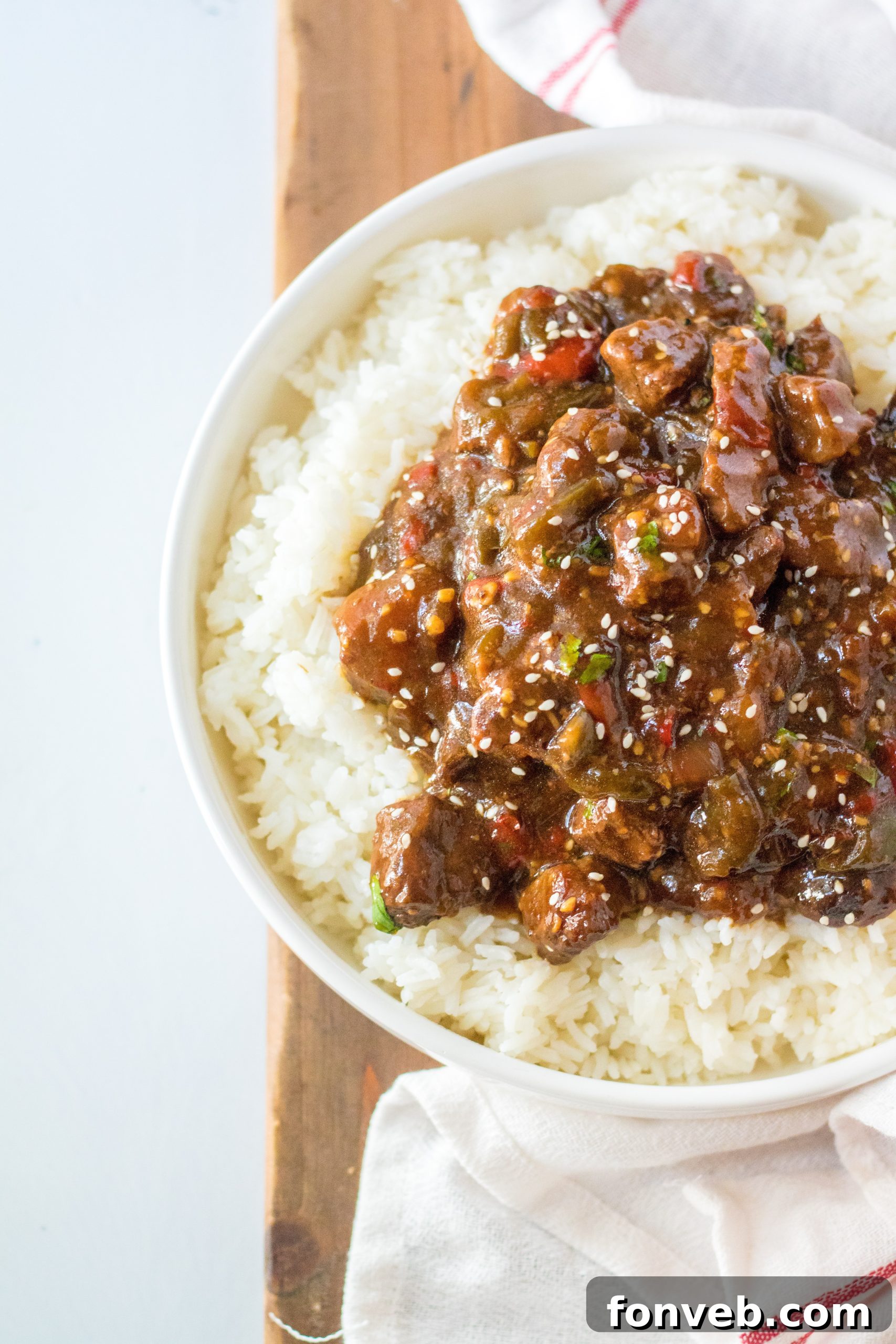 Hearty Slow Cooker Pepper Steak with Onions 12 Finished Slow Cooker Pepper Steak on a plate with rice.