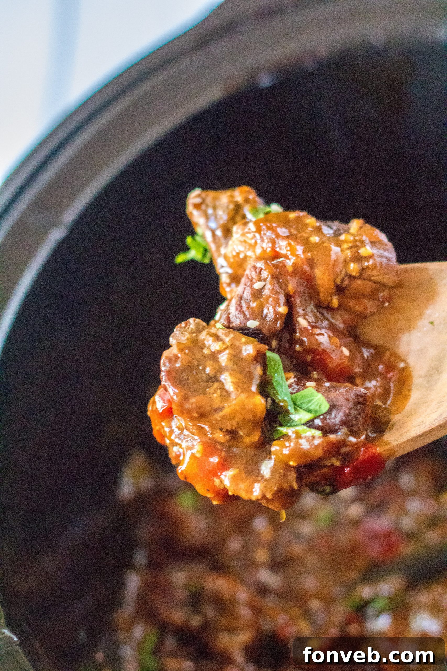 Hearty Slow Cooker Pepper Steak with Onions 7 Close-up of tender beef and peppers.
