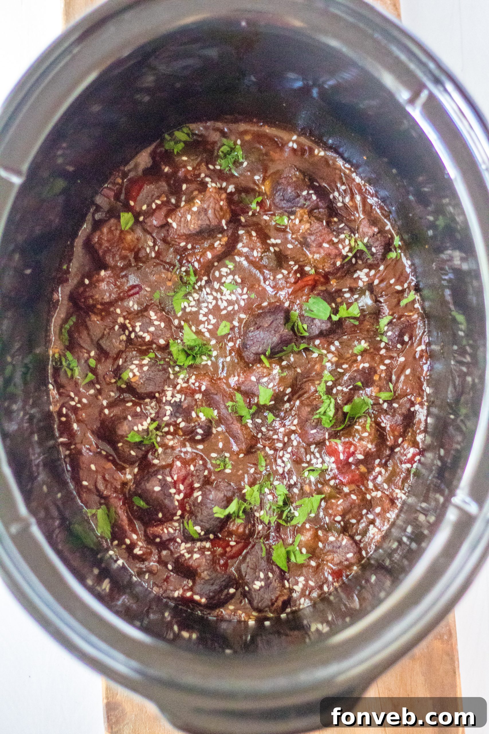 Hearty Slow Cooker Pepper Steak with Onions 8 Slow Cooker Pepper Steak with a spoon, ready to serve.