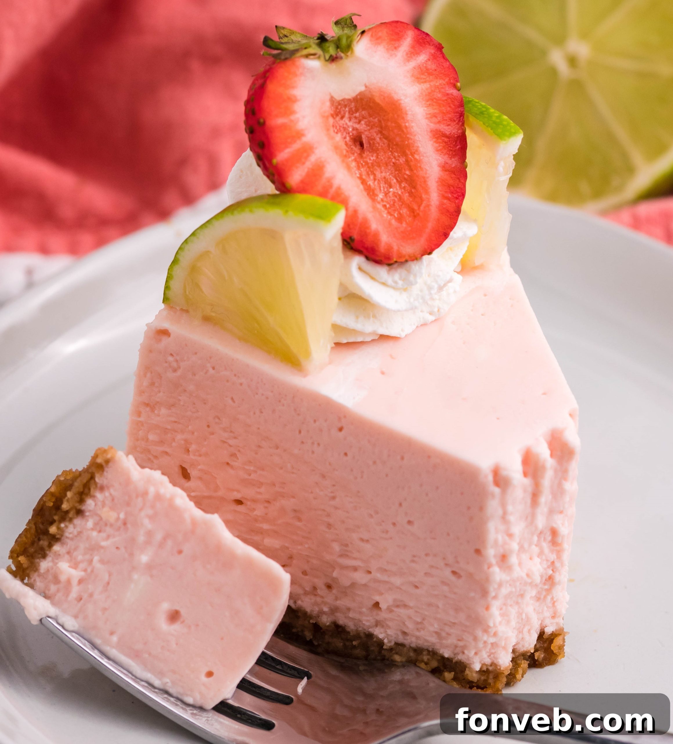 A slice of cheesecake with berries and whipped cream on a colorful plate.