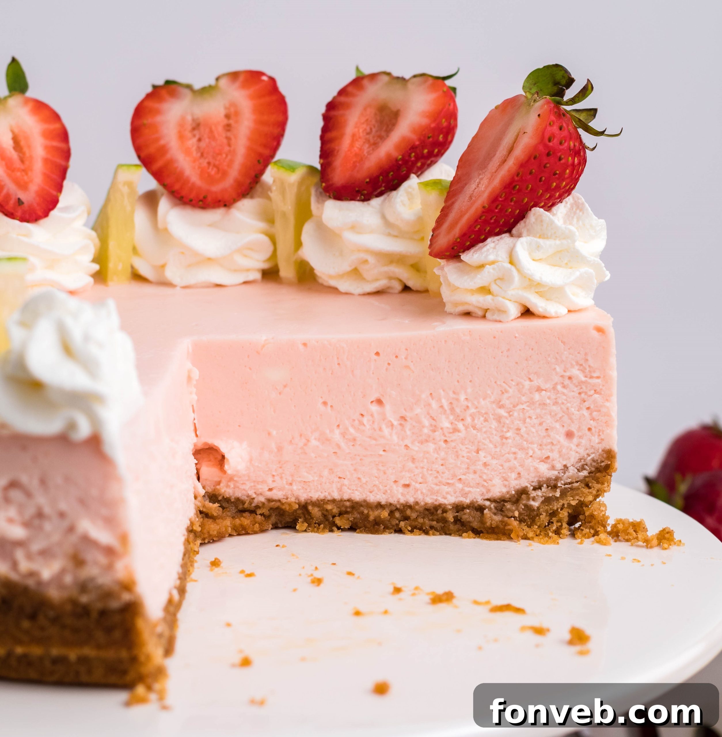 A whole Instant Pot Strawberry Daiquiri Cheesecake with various toppings and decorations.
