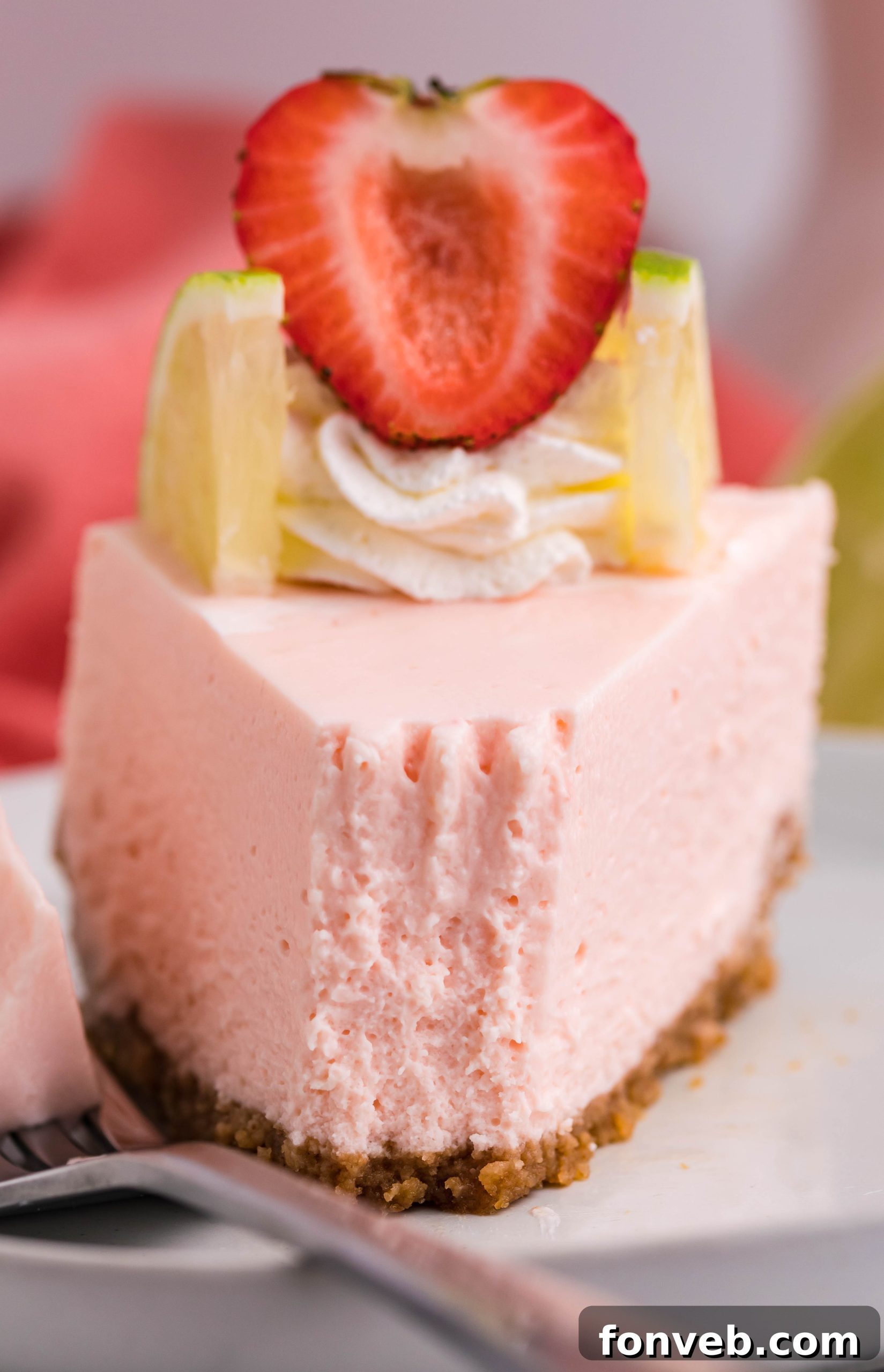 A slice of cheesecake on a plate with berries, focus on the creamy texture.