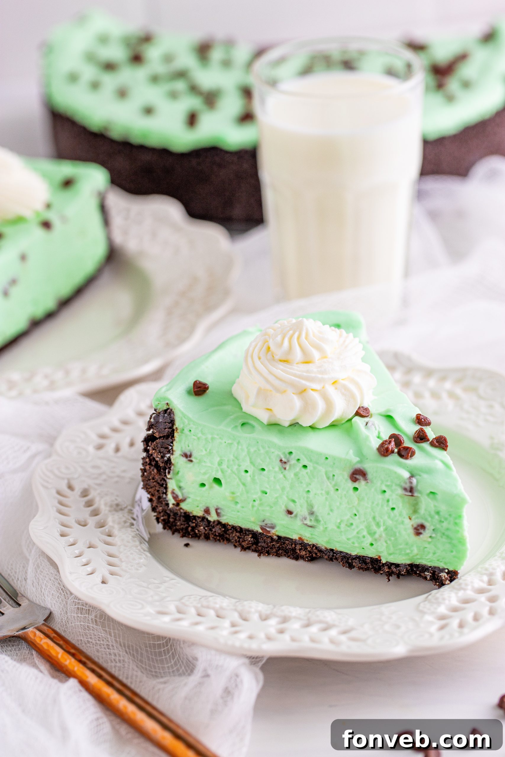 A close-up shot of the creamy green filling of the No Bake Mint Chocolate Chip Cheesecake, showing visible chocolate chips.