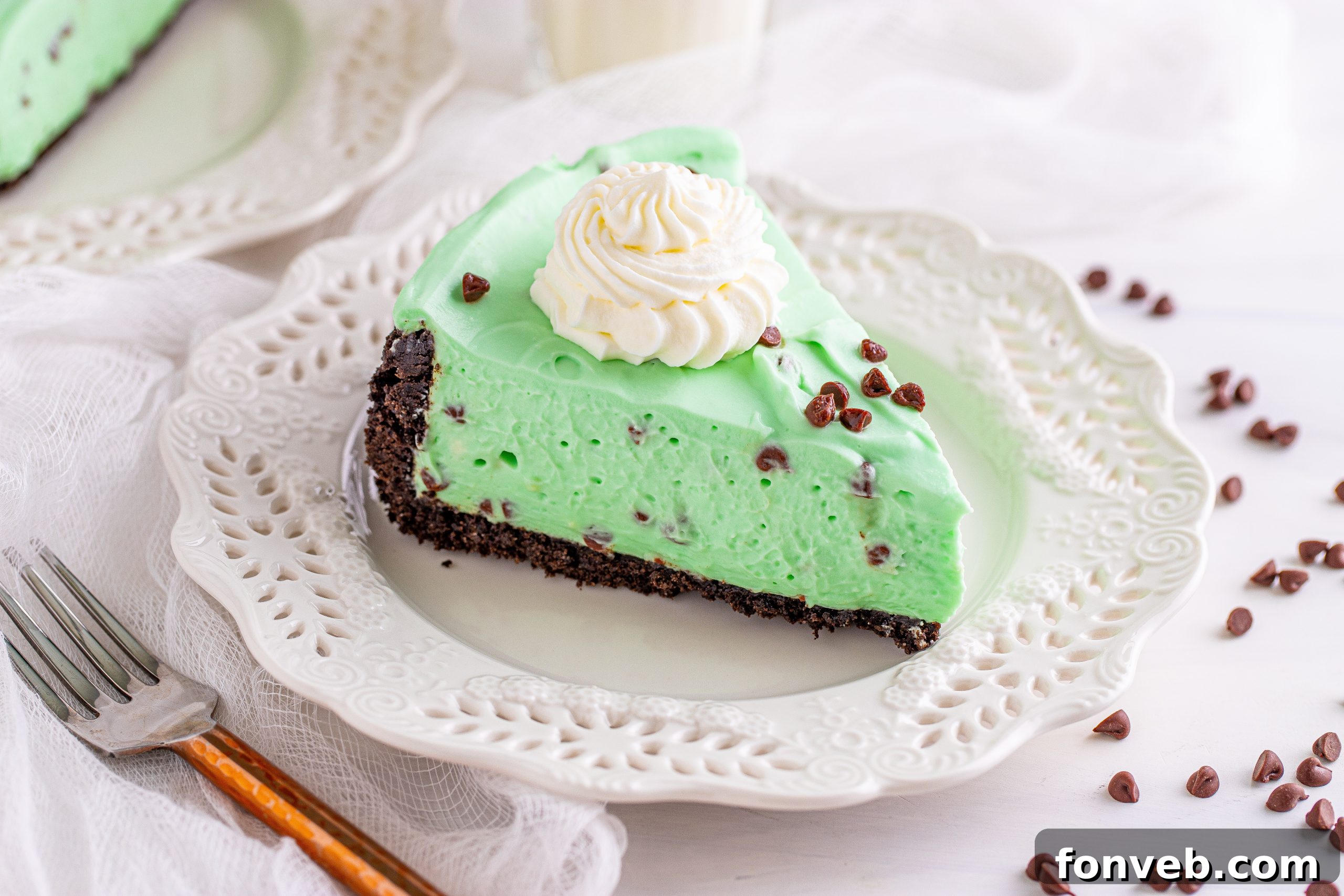 A close-up of the smooth, green mint chocolate chip cheesecake filling.