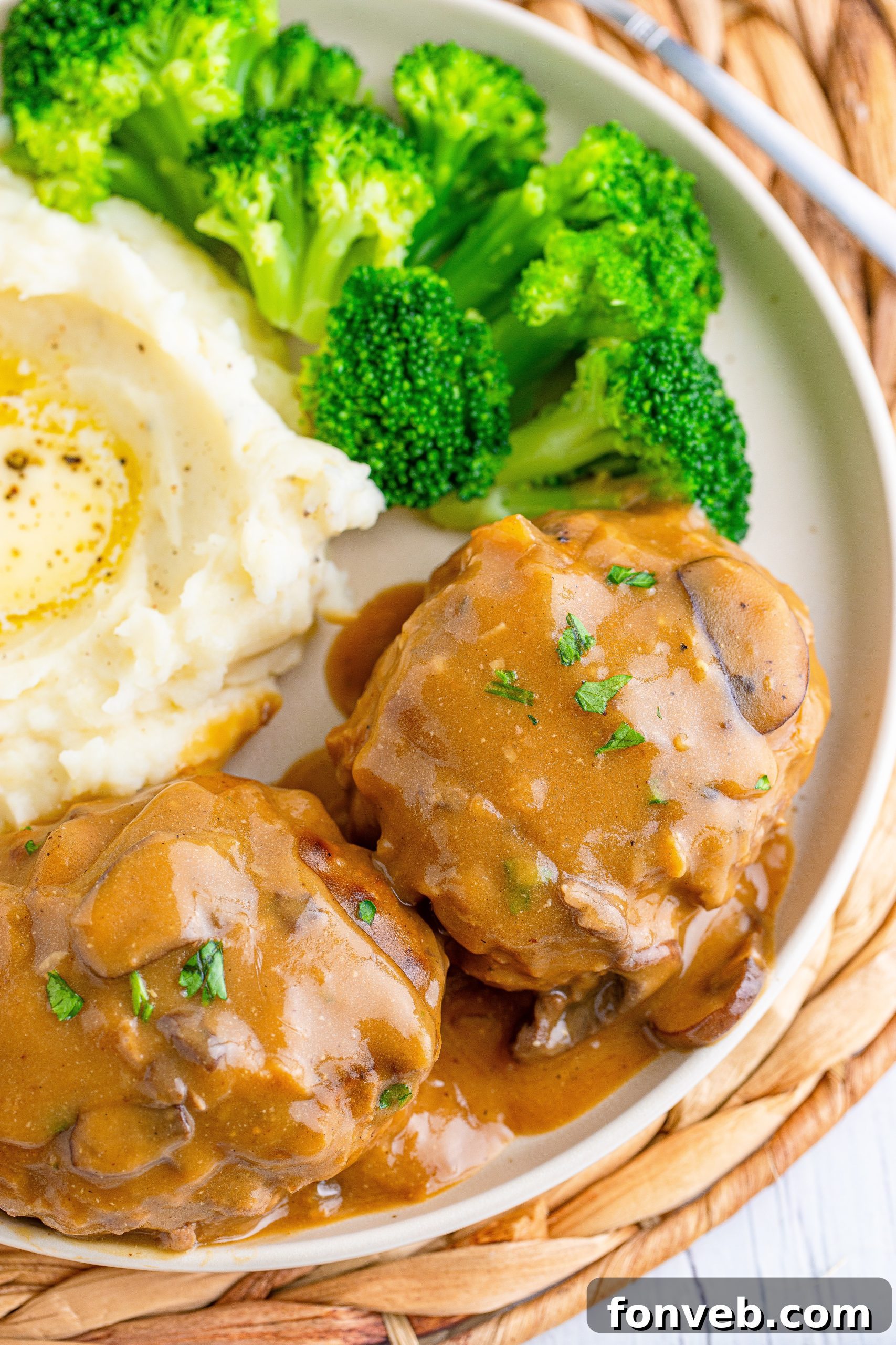 Hearty Salisbury Steaks with Rich Gravy 2 Delicious Salisbury Steaks smothered in rich brown mushroom gravy, ready to be served with mashed potatoes.