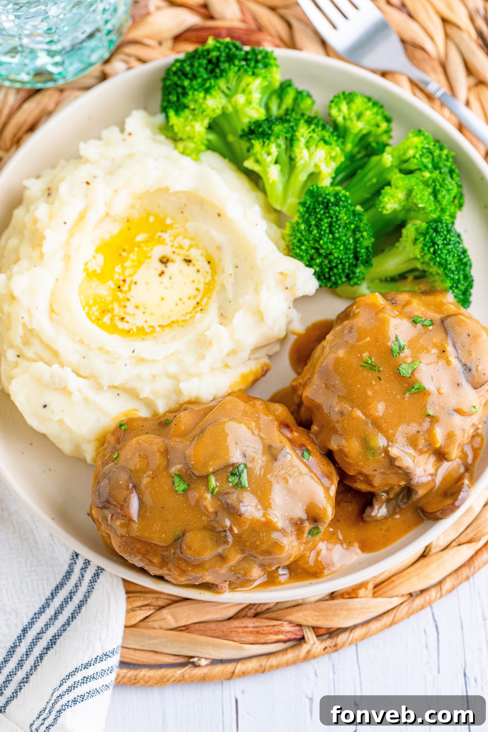 Hearty Salisbury Steaks with Rich Gravy 11 Cooked Salisbury Steaks resting on a plate, covered with foil to keep warm.