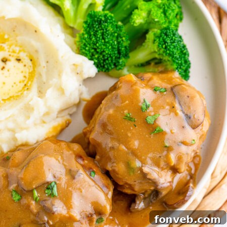 Hearty Salisbury Steaks with Rich Gravy 16 A finished plate of Salisbury Steaks with Gravy, garnished with parsley.