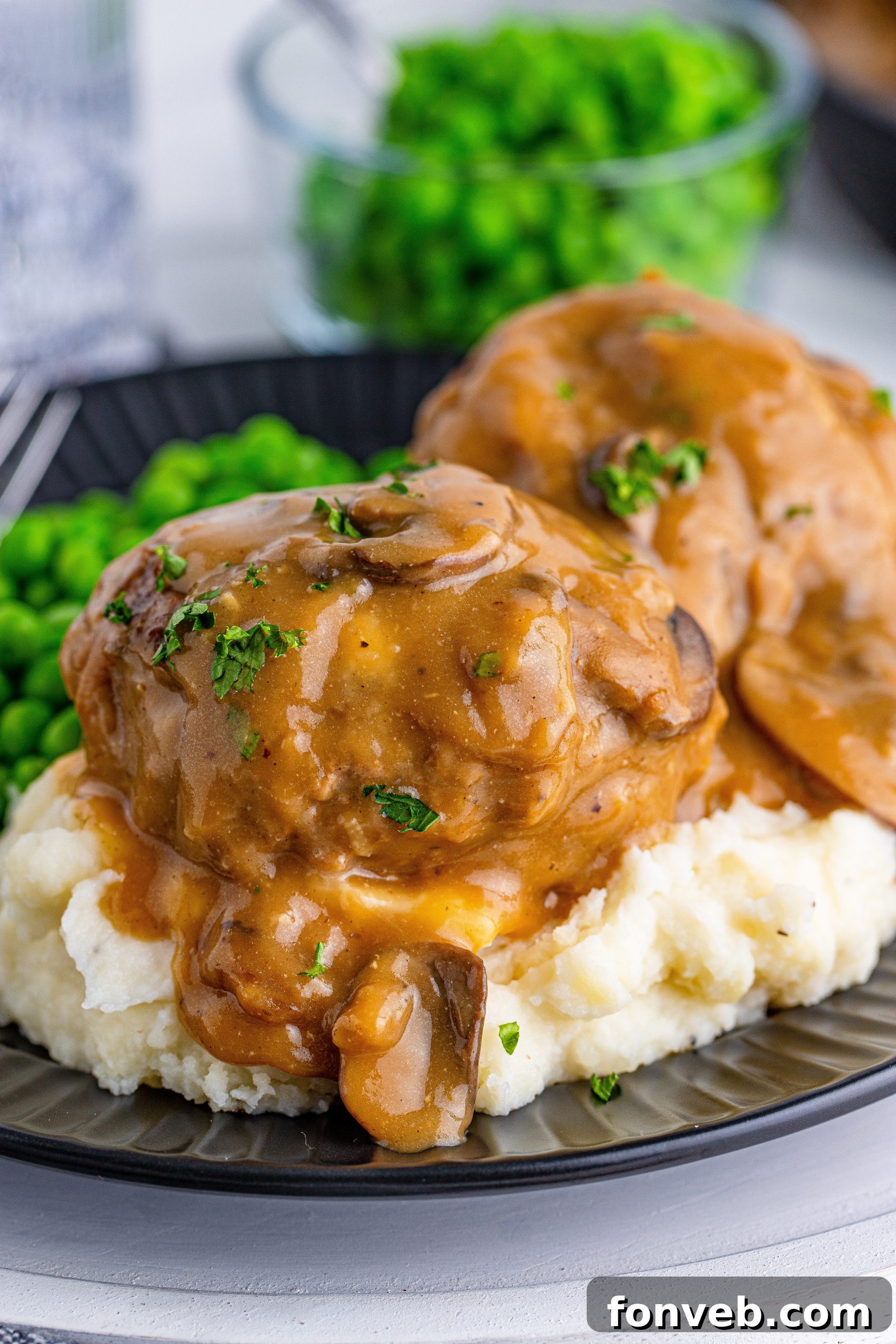 Hearty Salisbury Steaks with Rich Gravy 10 Close-up of sliced baby bella mushrooms, ready for the gravy.