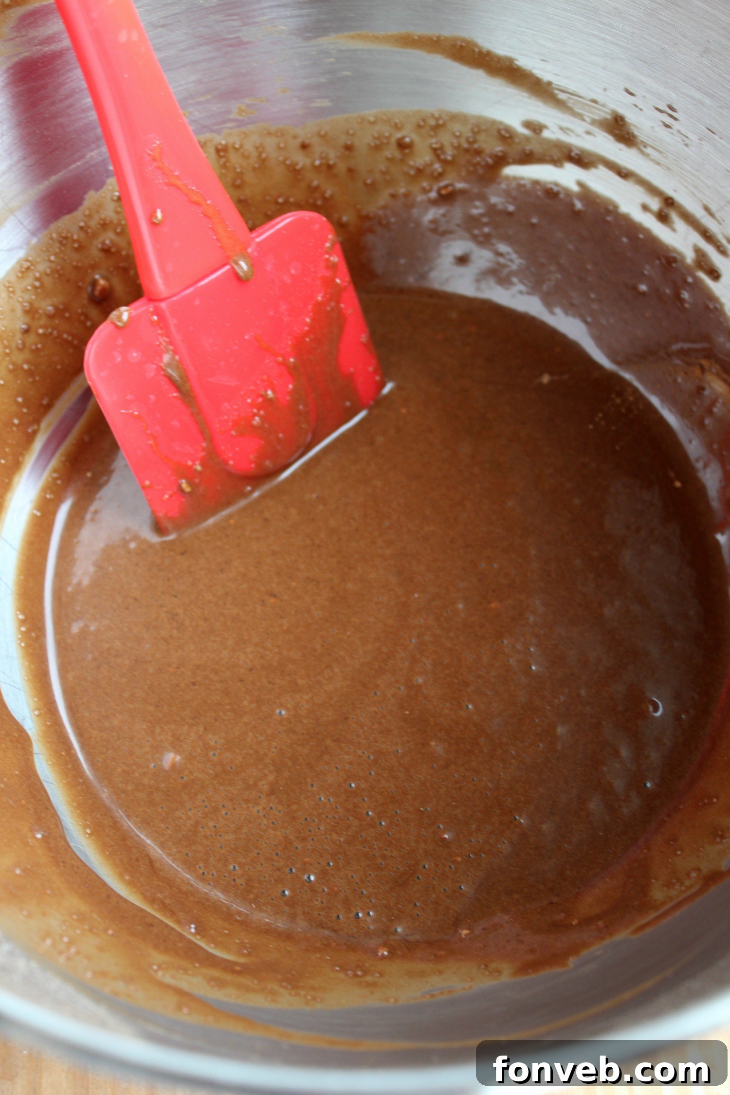 Close-up of cupcake batter being mixed in a bowl, showing the initial stages of preparing Thin Mint Cupcakes.