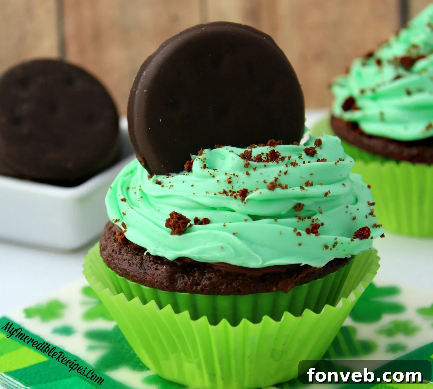 The ultimate hero shot of a Thin Mint Cupcake, perfectly baked, frosted, and adorned, showcasing its mouth-watering appeal.