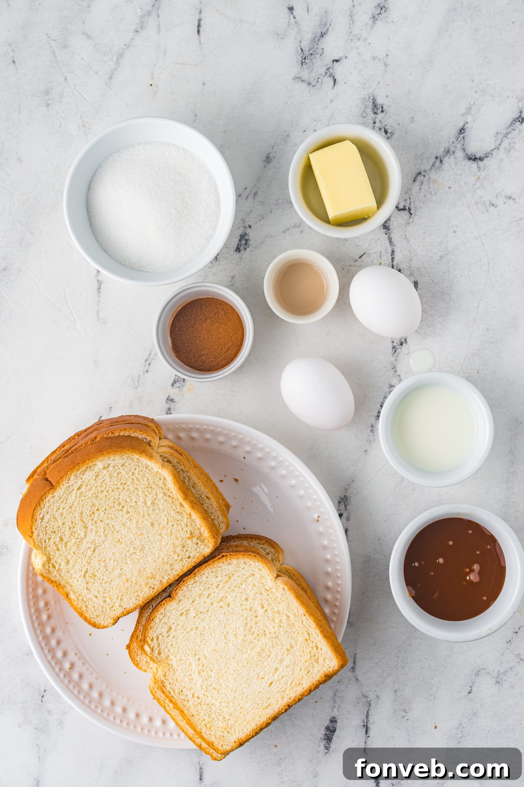 A close-up shot of several Churro French Toast Roll Ups, showing their golden-brown exterior and cinnamon sugar coating.
