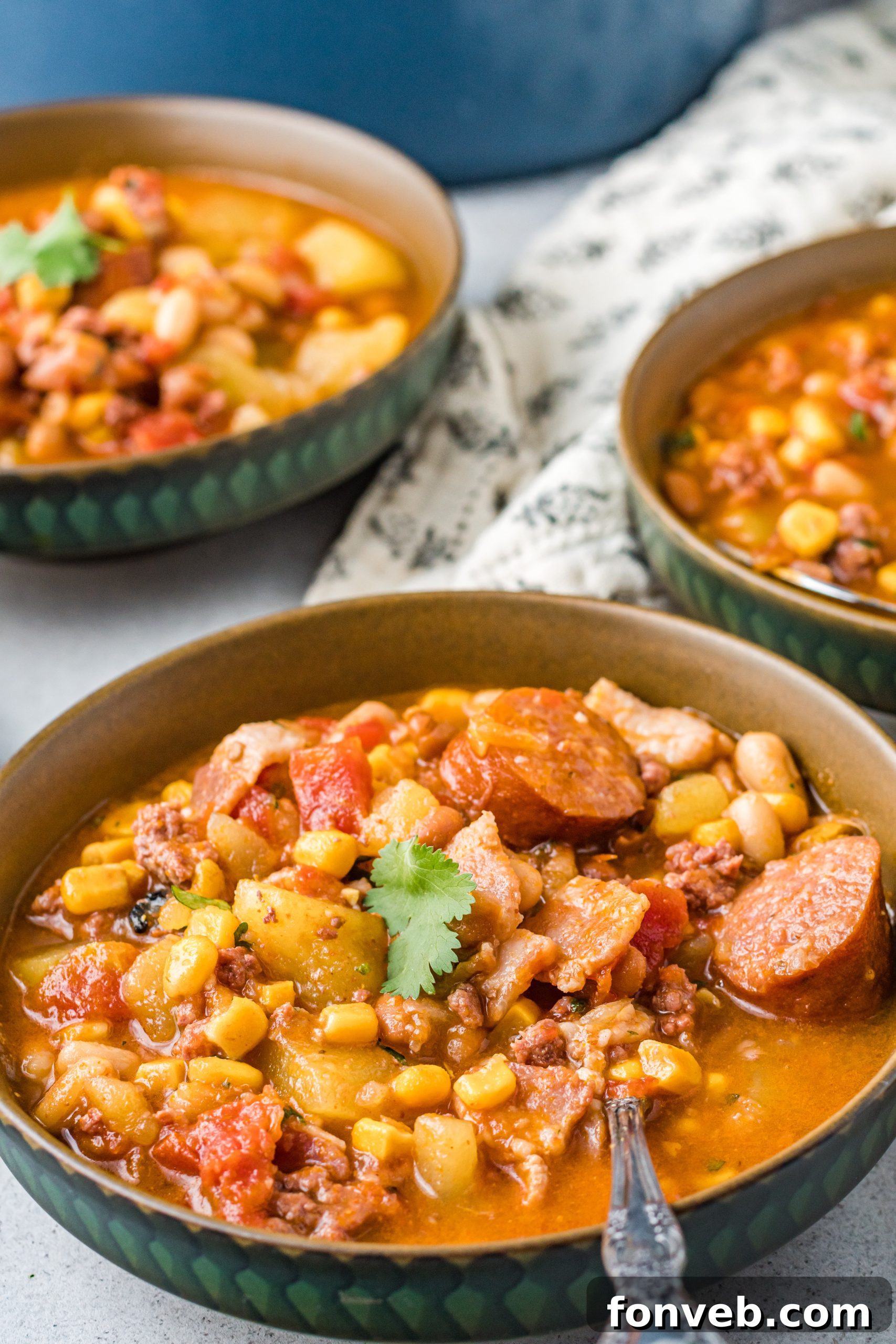 Wrangler's Hearty Stew 11 A spoon scooping a generous portion of thick, flavorful Cowboy Stew from a serving bowl.