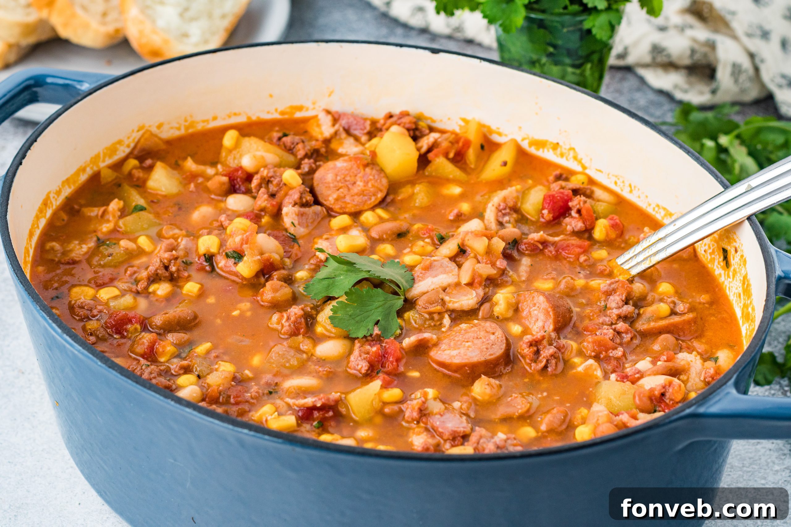 Wrangler's Hearty Stew 13 A close-up shot of Cowboy Stew in a bowl, garnished with a sprinkle of fresh green herbs.