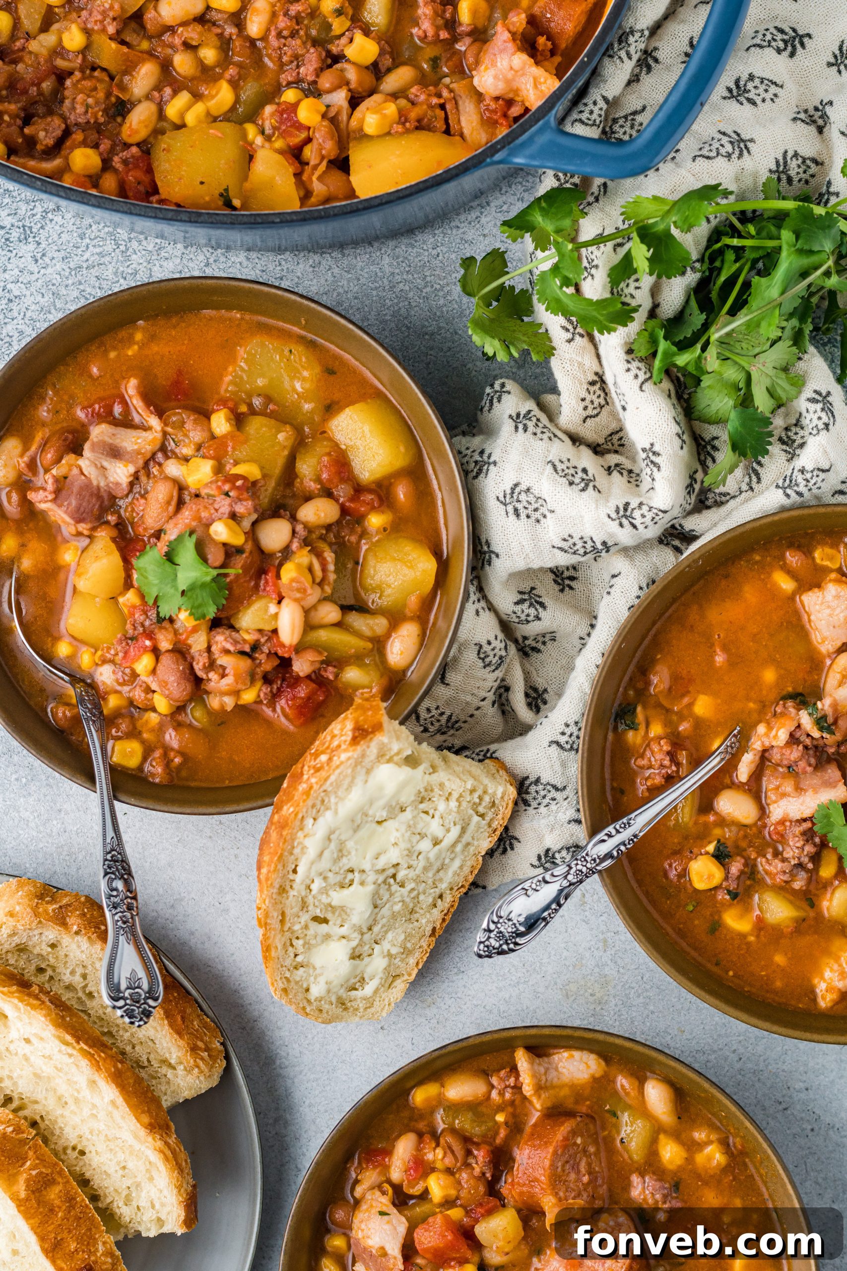 Wrangler's Hearty Stew 7 A single serving of Cowboy Stew in a white bowl, garnished with fresh herbs and served with a spoon.
