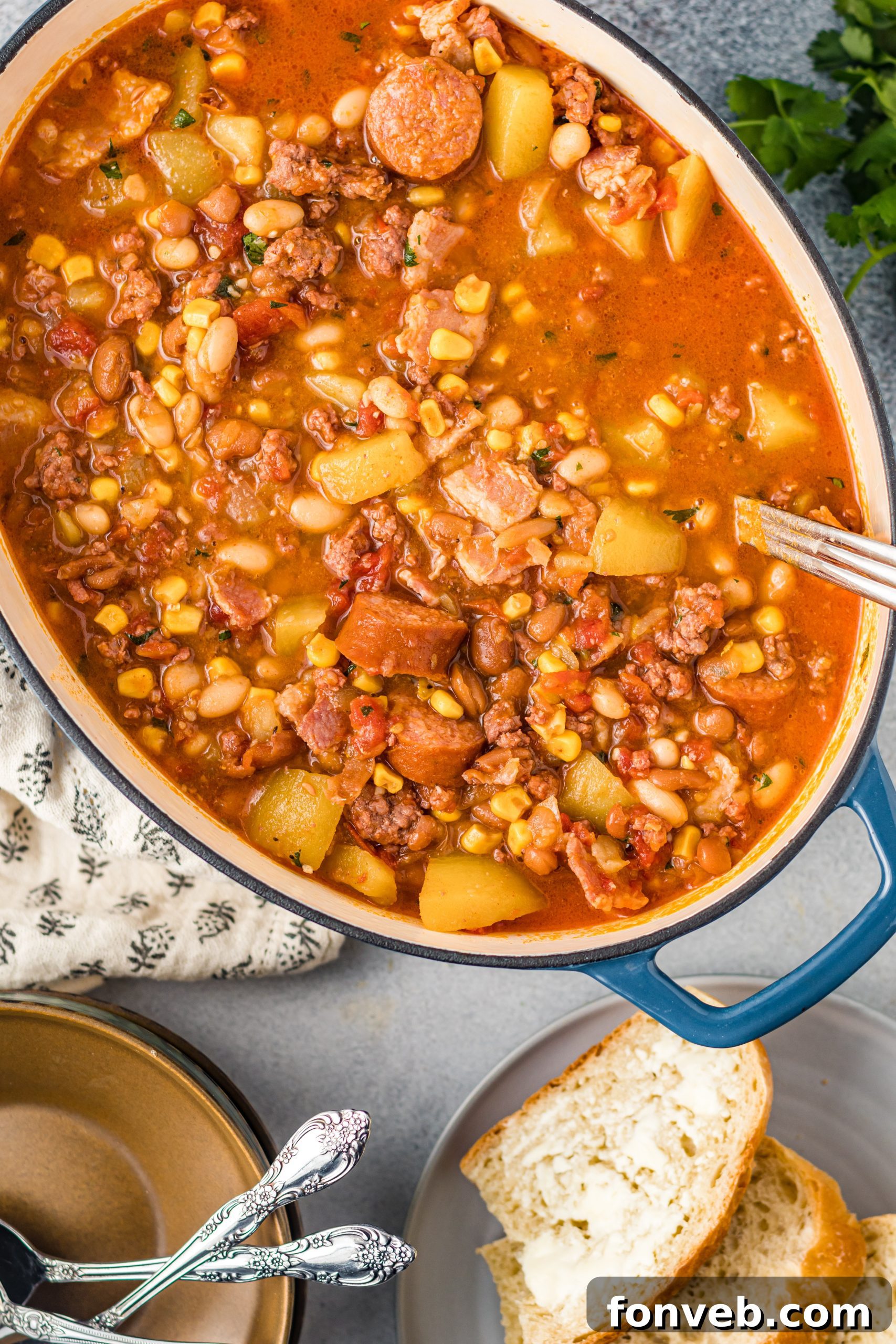 Wrangler's Hearty Stew 9 A cutting board with cooked bacon and slices of smoked sausage, key meat components of the stew.