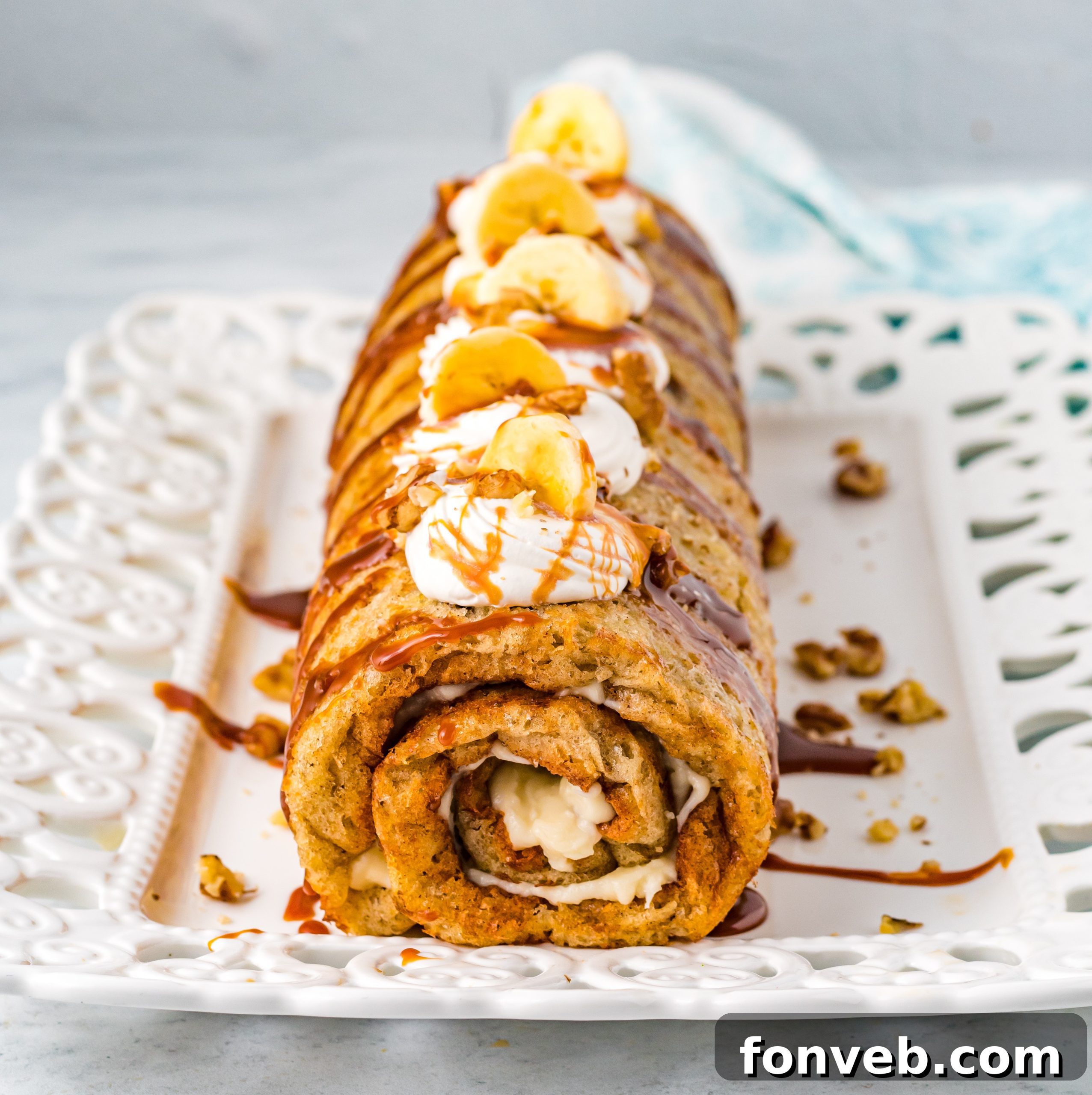 Close-up of a banana cake roll, showing the layers and creamy filling