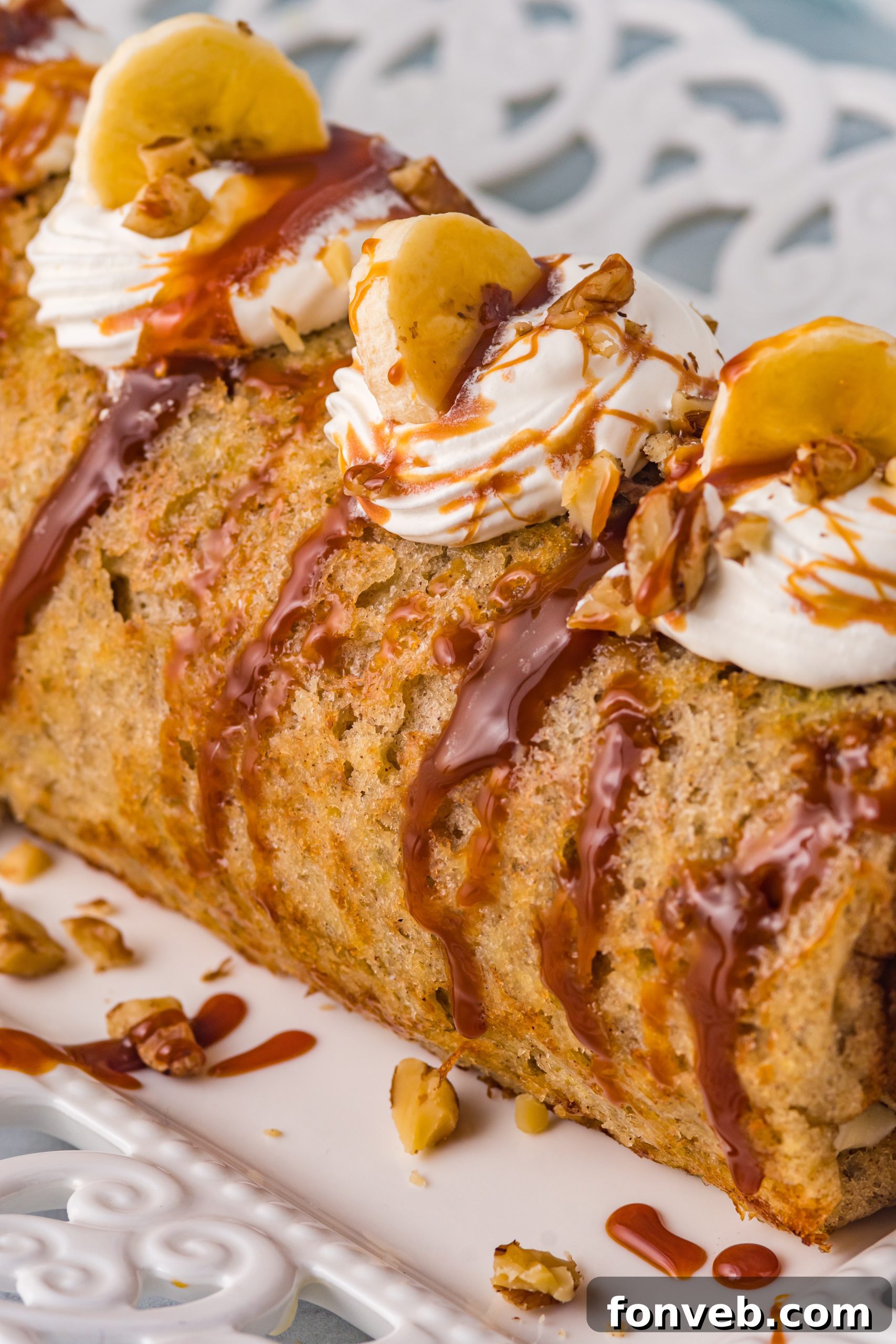 Close-up of the rolled banana cake, showing the rich caramel and cream cheese