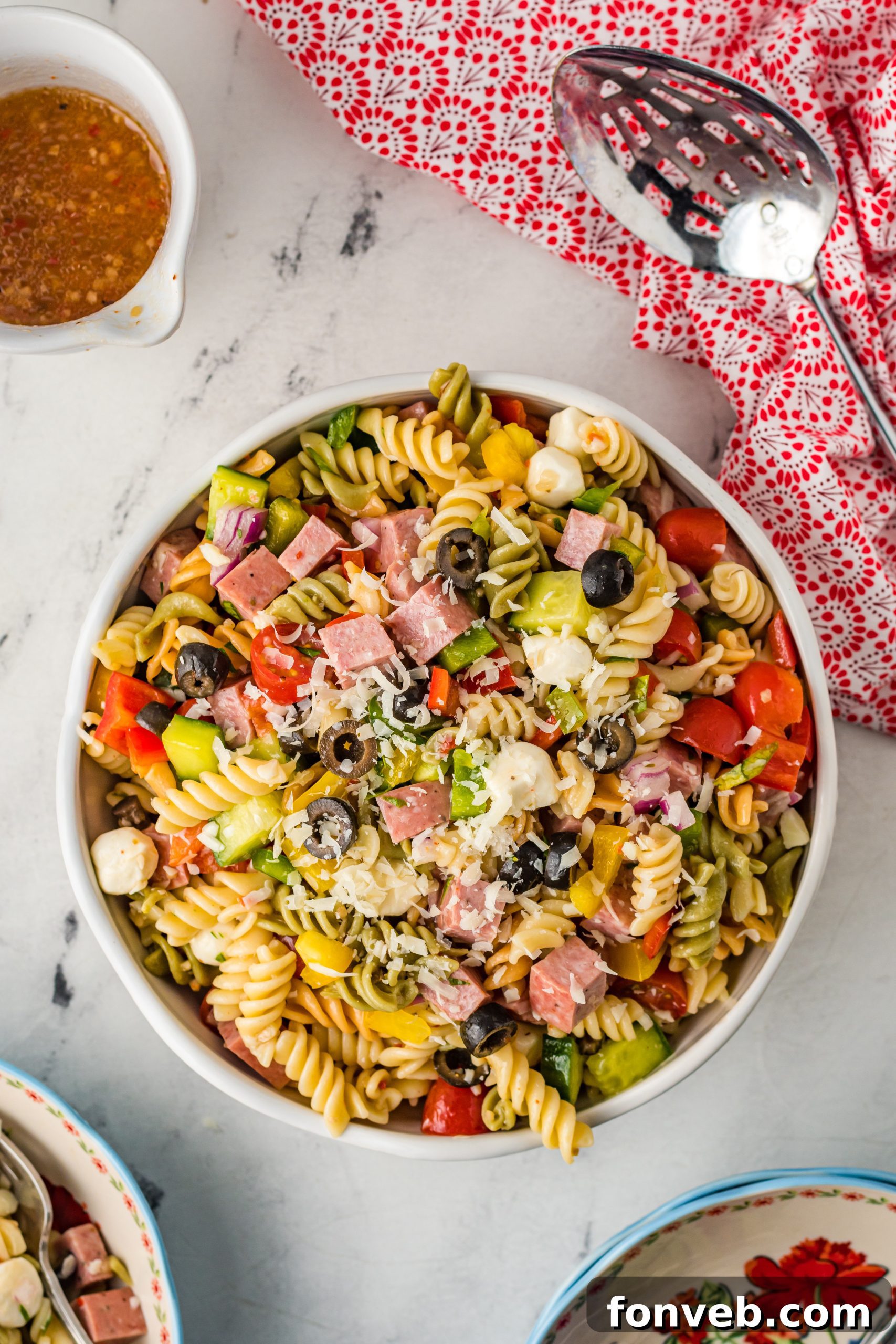 A large serving bowl filled with the completed Italian Pasta Salad, ready to be refrigerated or served.