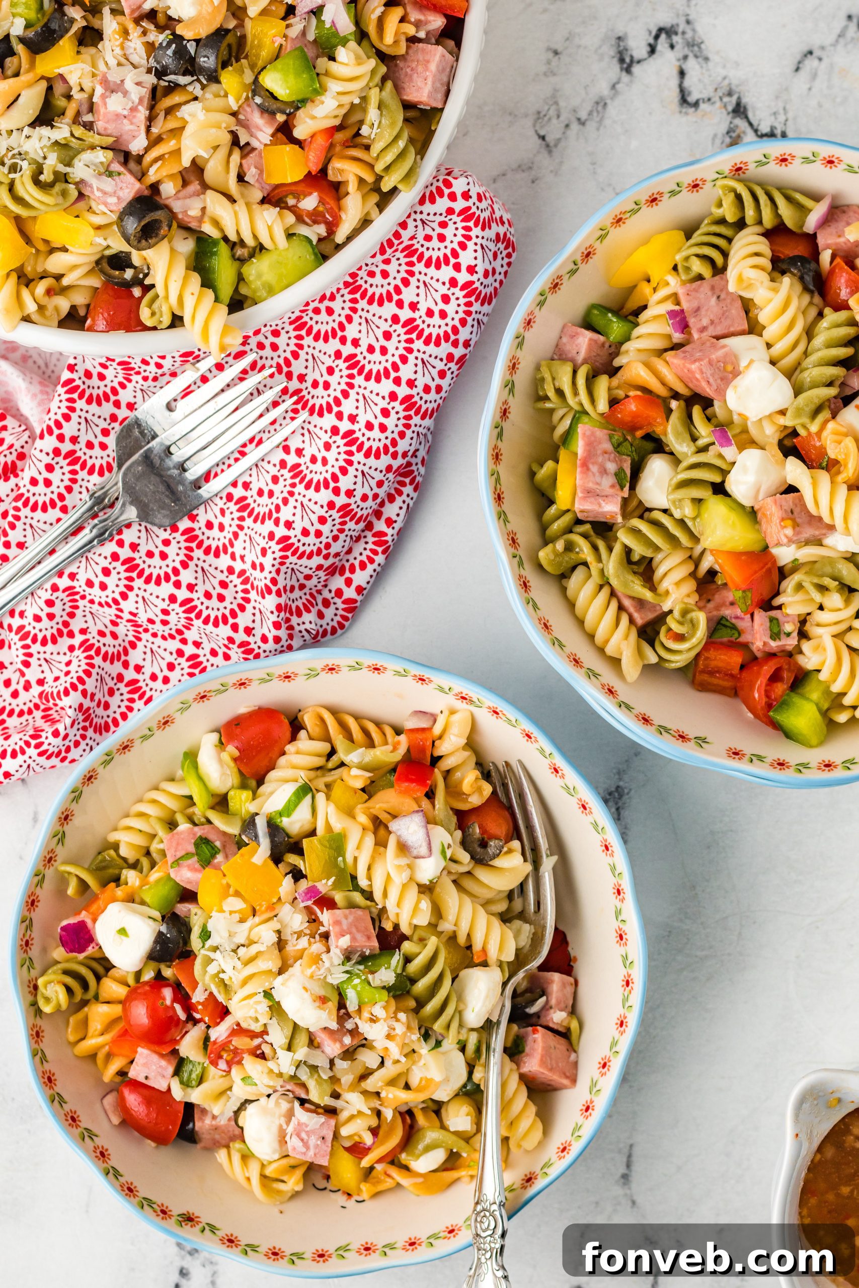 A bowl of cooked rotini pasta, ready to be mixed with other ingredients, showing the pasta's spiral shape.