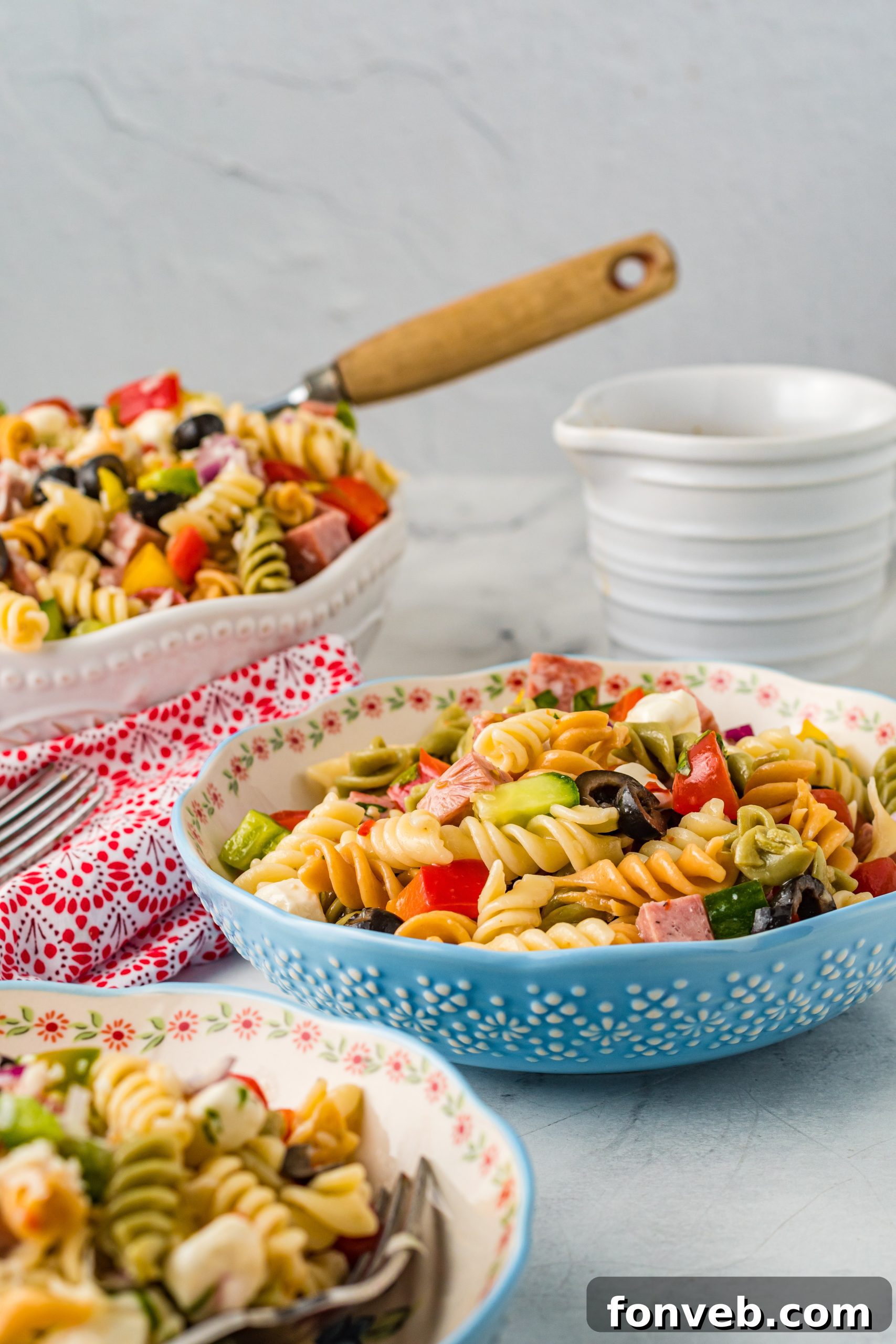 A bottle of Italian dressing alongside a measuring cup, indicating the dressing is a key component.