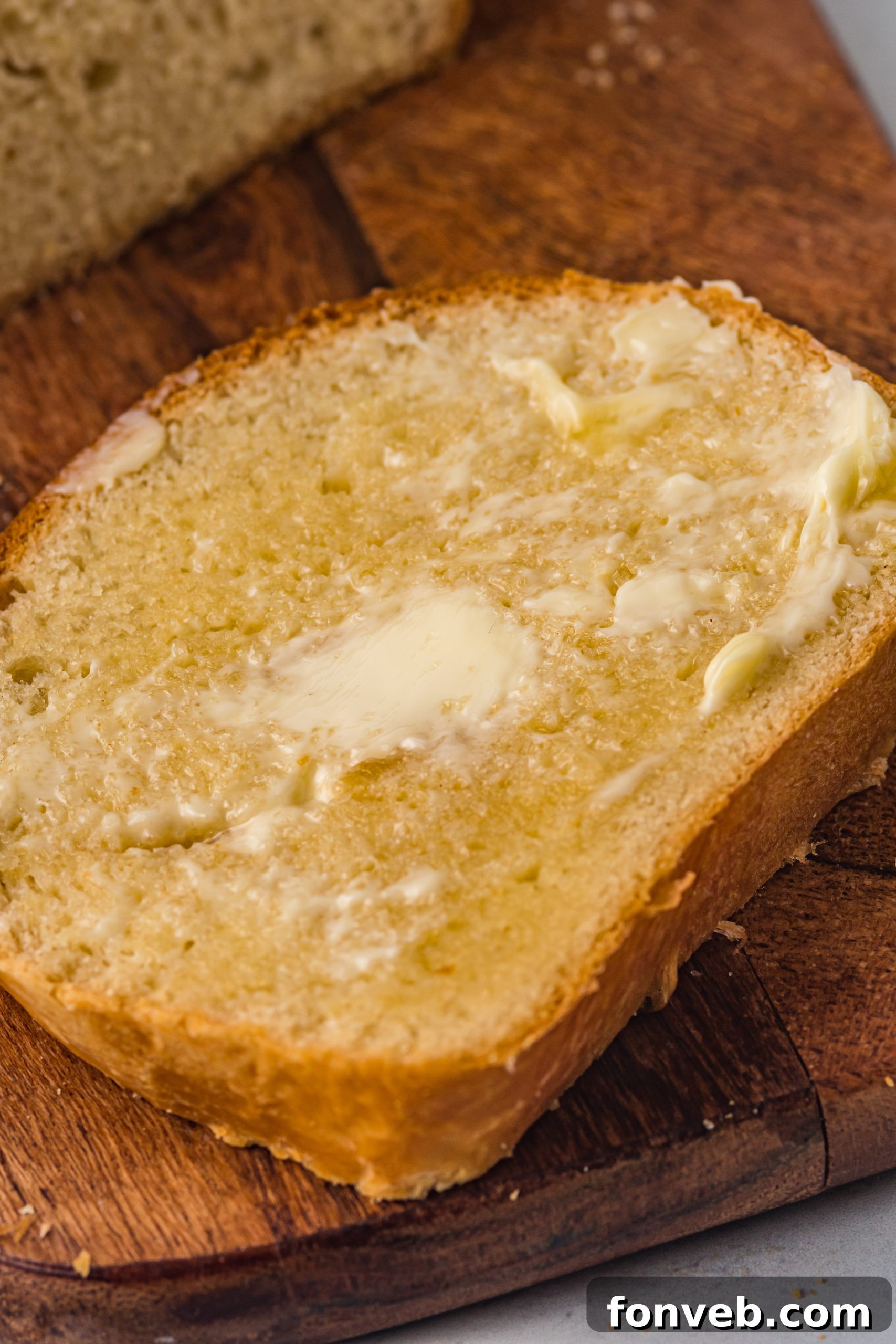 Freshly baked loaves of Amish White Bread cooling on a wire rack.