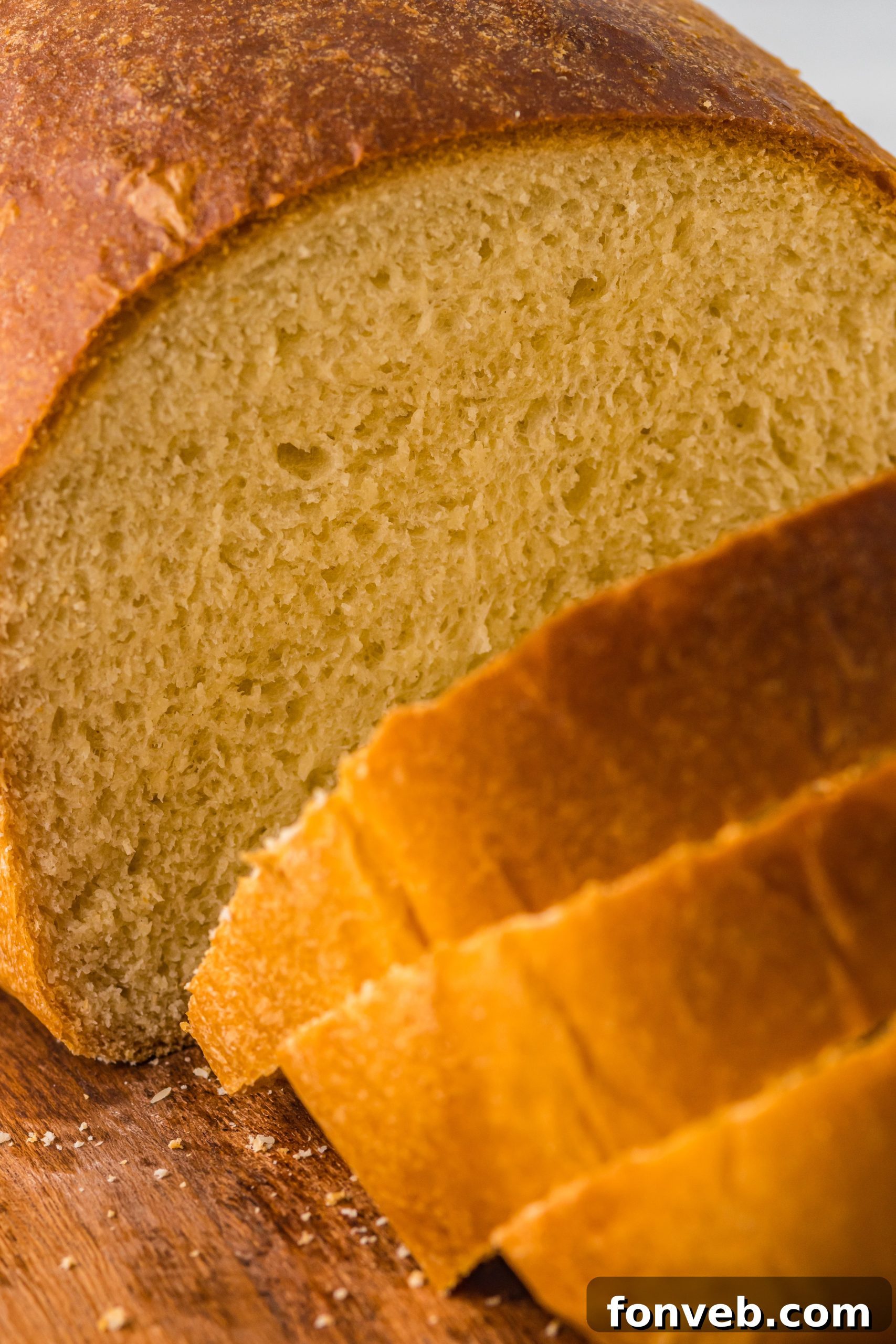 Two loaves of bread on a cooling rack, one with a cinnamon swirl.