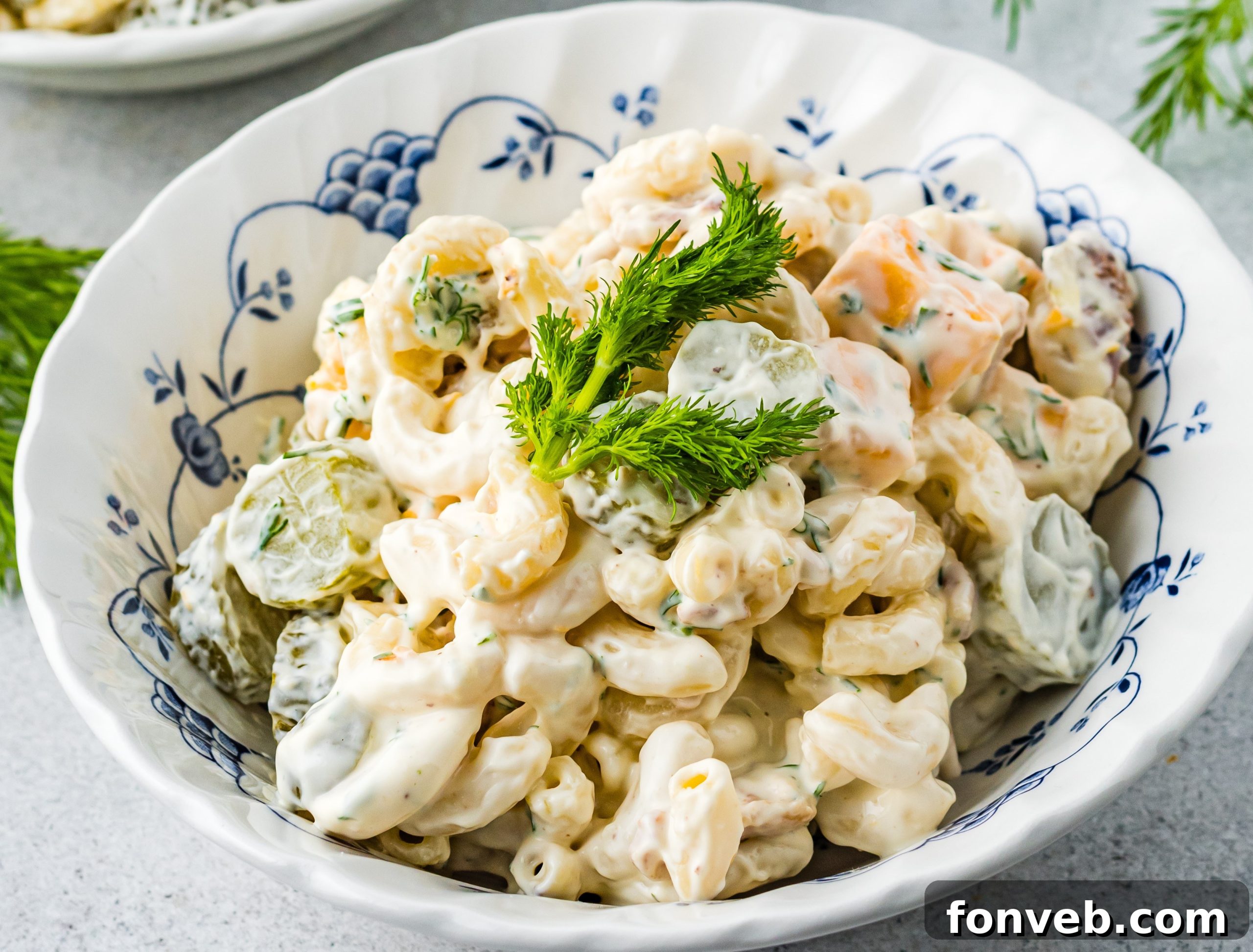 Dill Pickle Pasta Salad presented in a clean white bowl, highlighted by fresh dill, inviting a closer look.