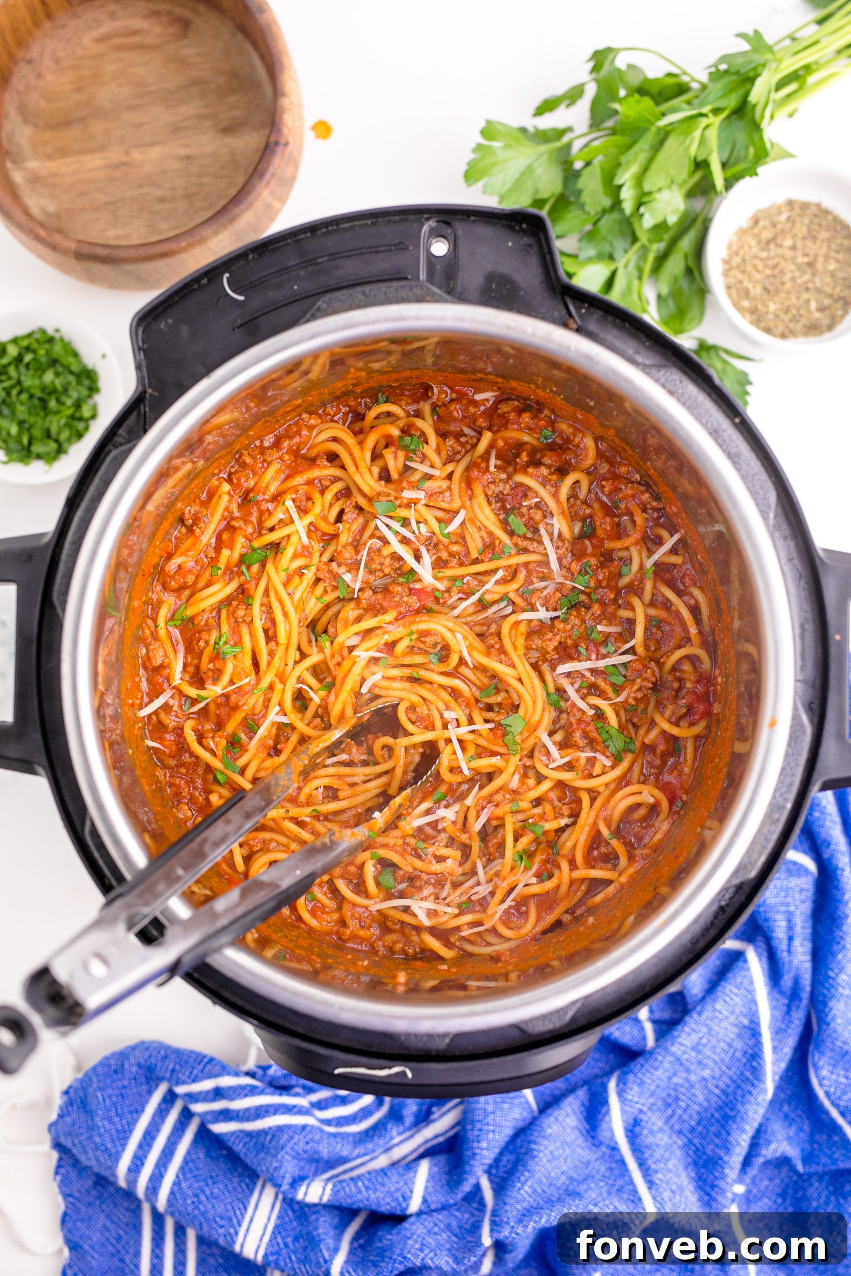 Instant Pot Spaghetti inthe instant pot being mixed with tongs over head shot